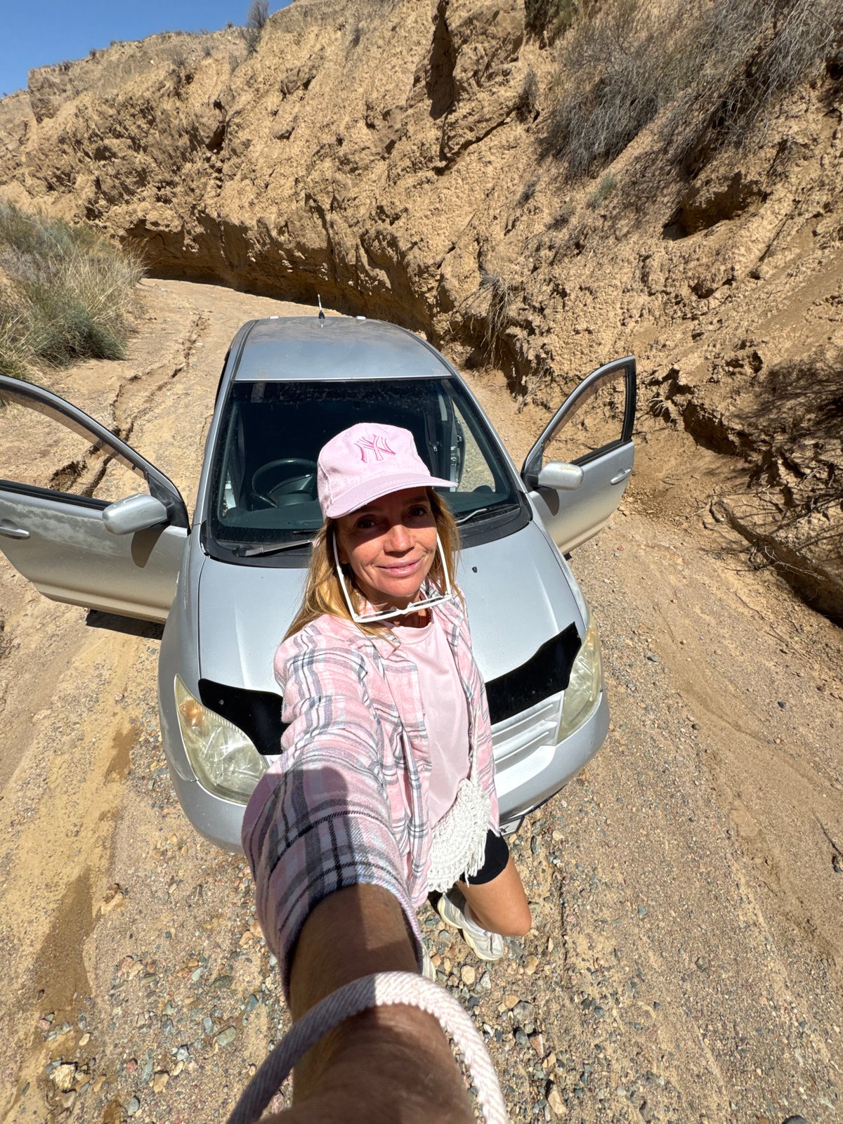 Woman explores Kyrgyzstan canyon terrain during early morning hike