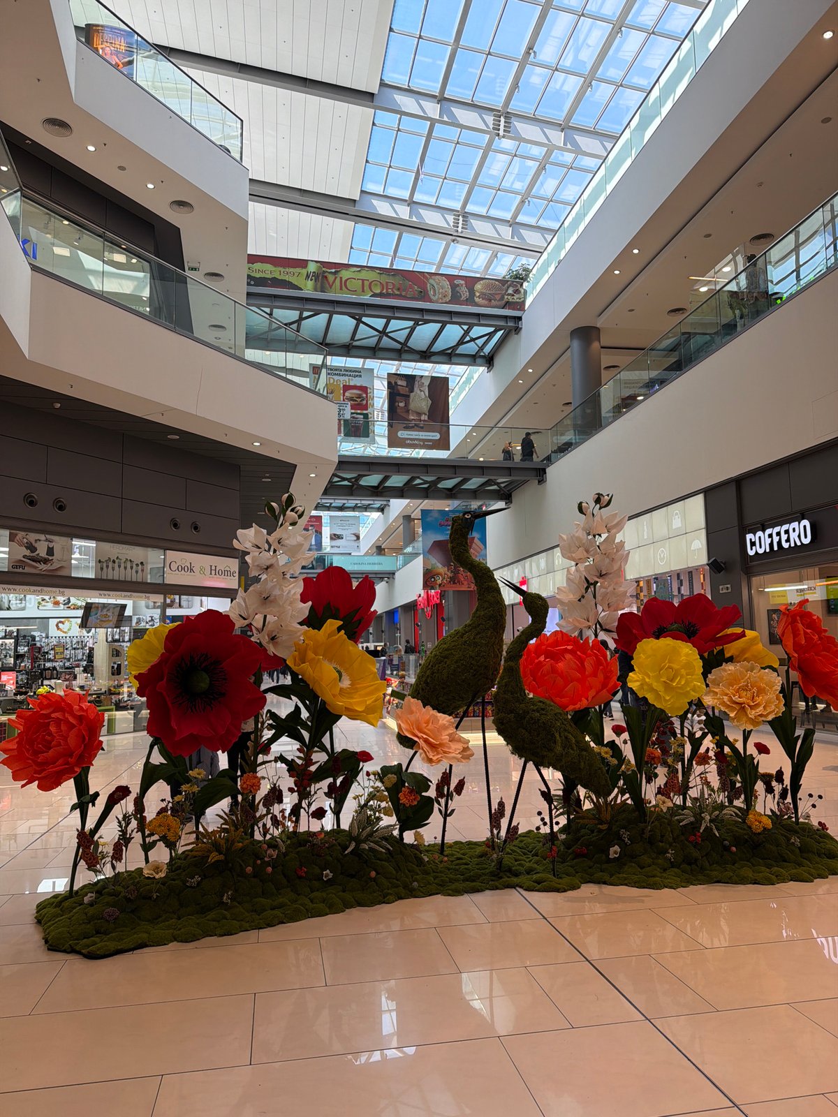 Floral art installation with moss birds displayed in Sofia mall