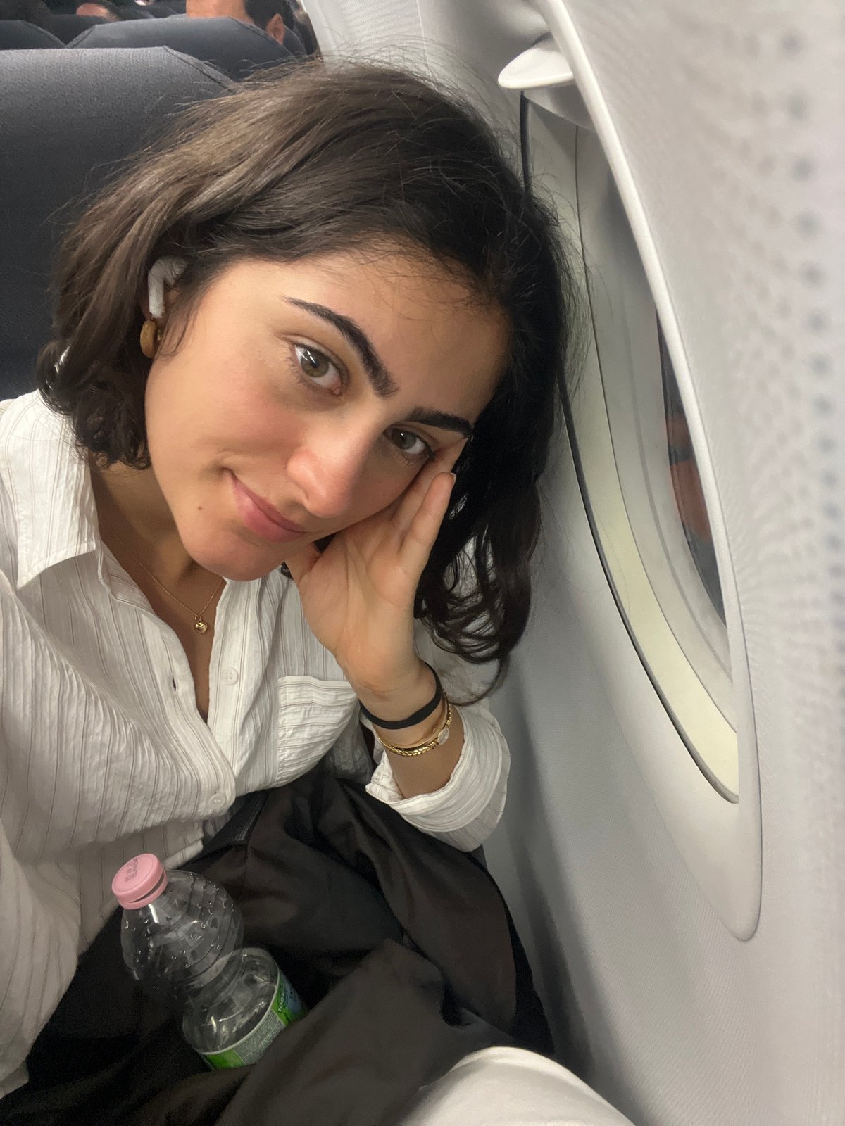 Woman rests aboard aircraft near Paris airport