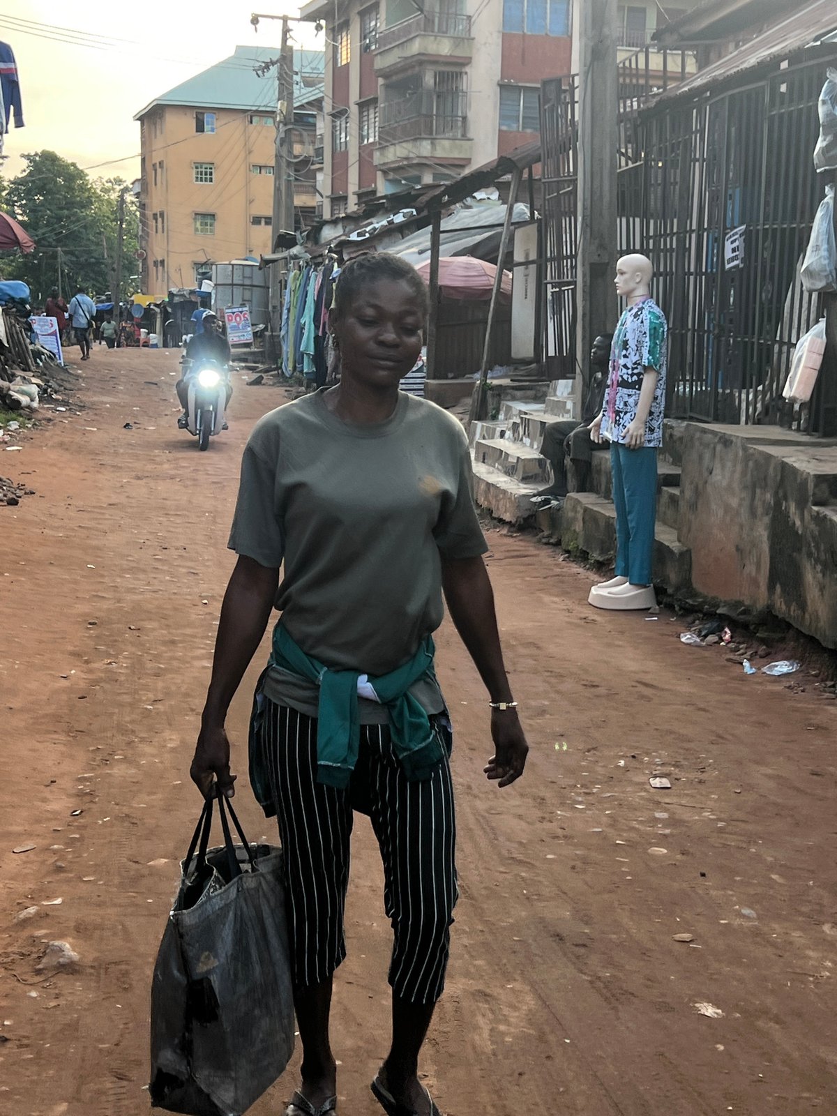 Afternoon foot traffic through Nkpor's busy market street.