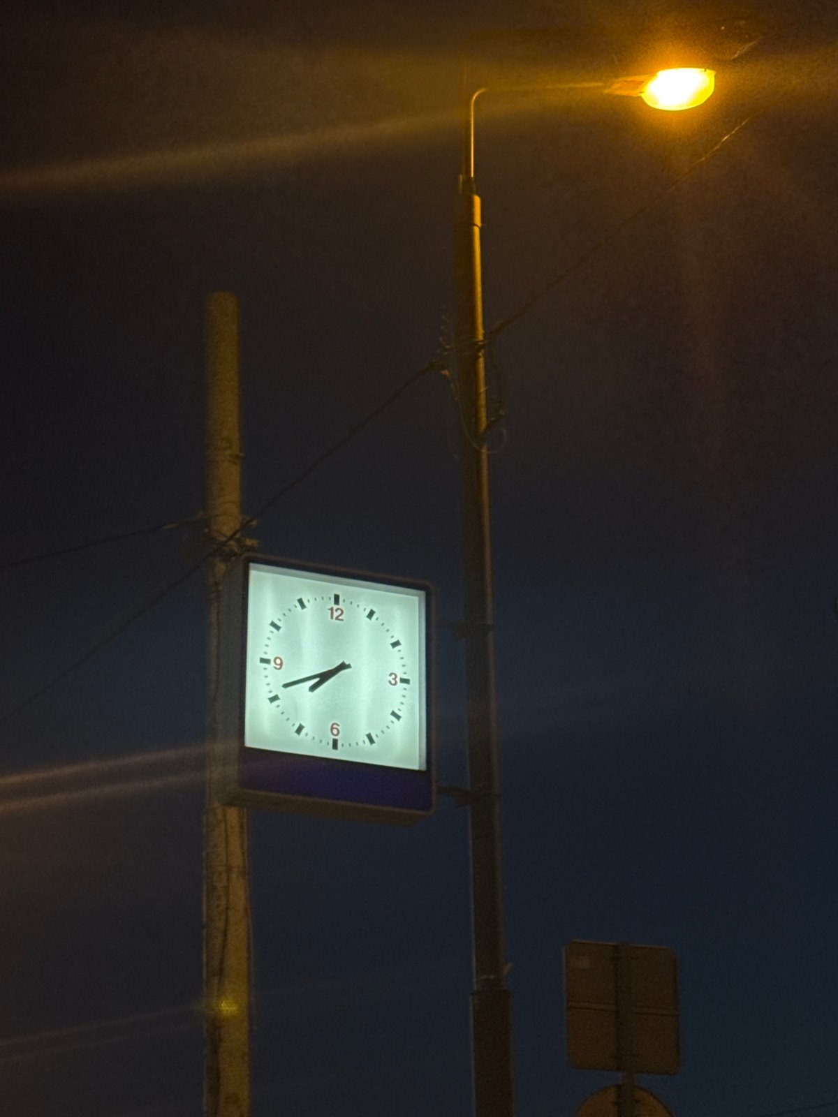 Moscow evening scenes captured at dusk with street clock