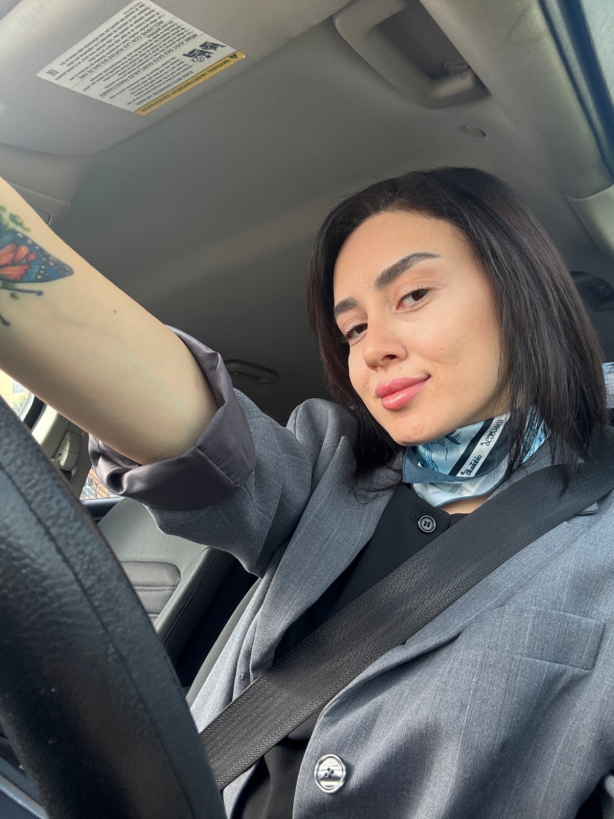 Woman in gray blazer spotted in car, elevator in Tbilisi