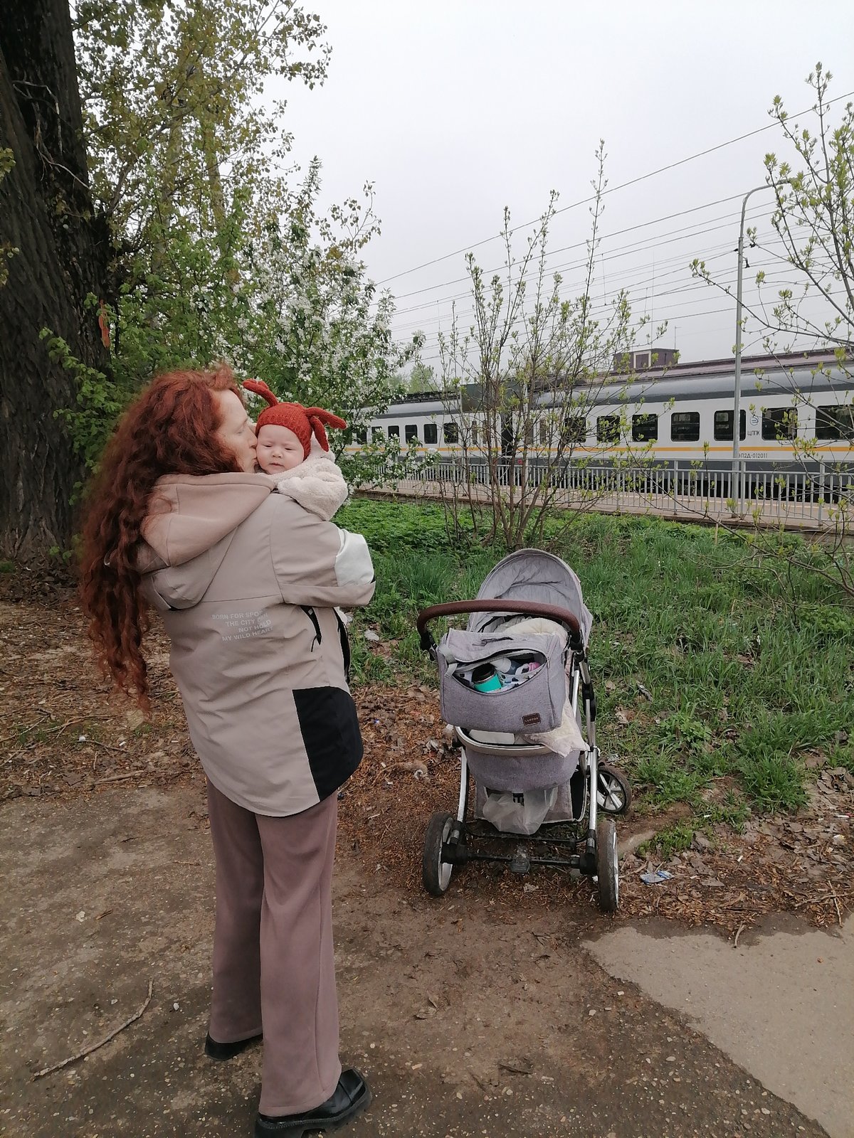 Mother and baby enjoy spring afternoon in Yuдино, Russia