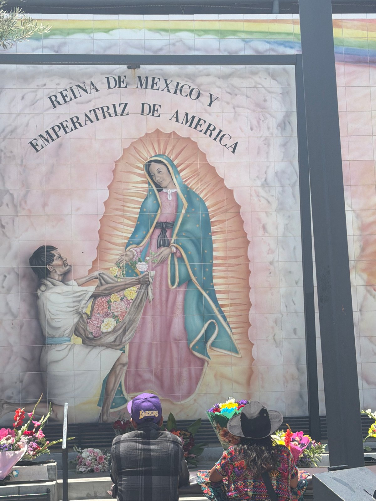 Visitor documents historical markers at El Pueblo monument