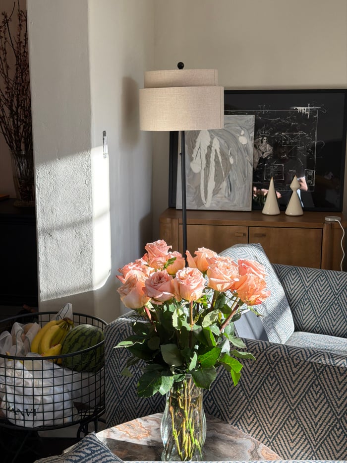 Pink roses arranged in glass vase observed in Los Angeles home
