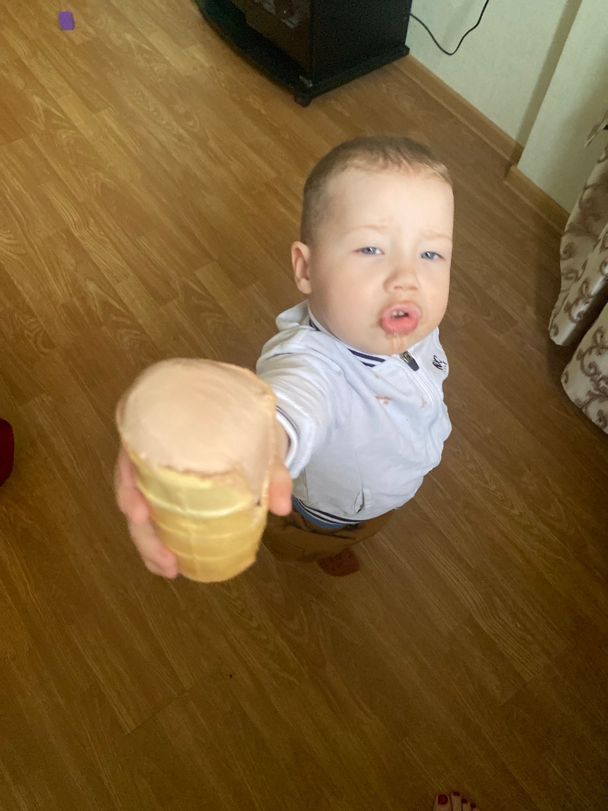 Child enjoys ice cream amid everyday Sochi street scenes