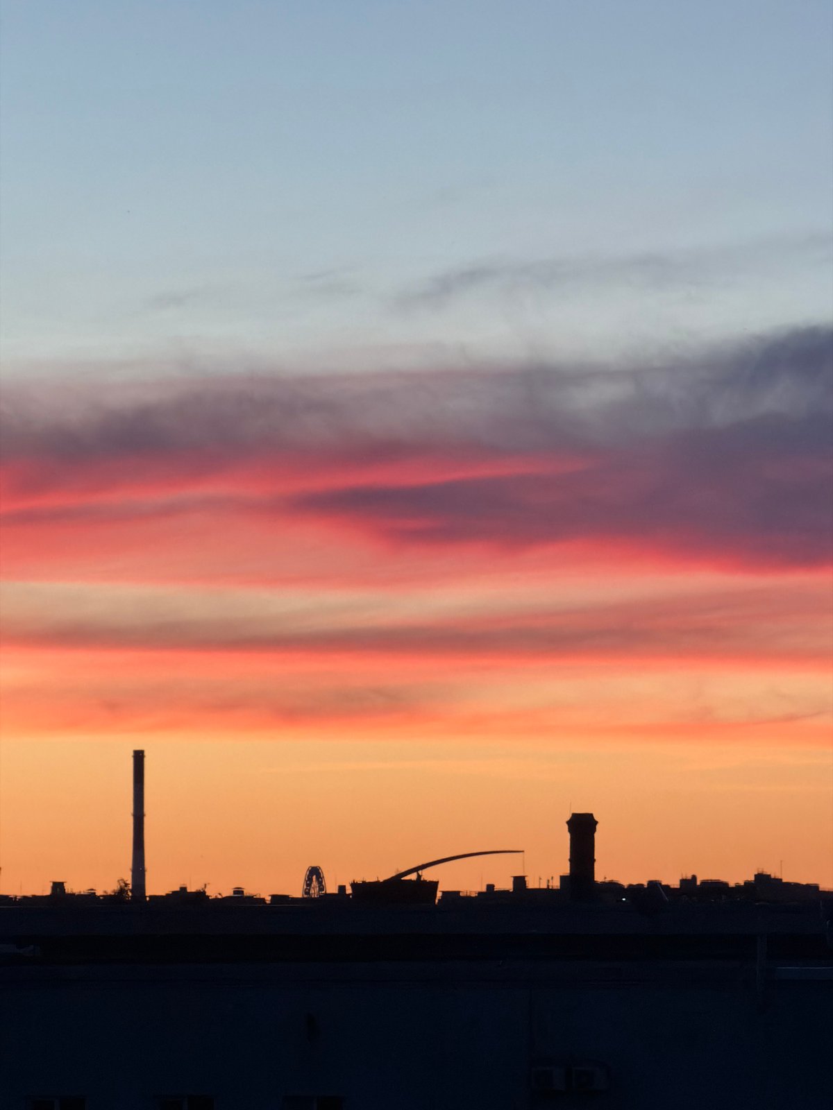 Sunset observed over industrial Russian cityscape during evening hours