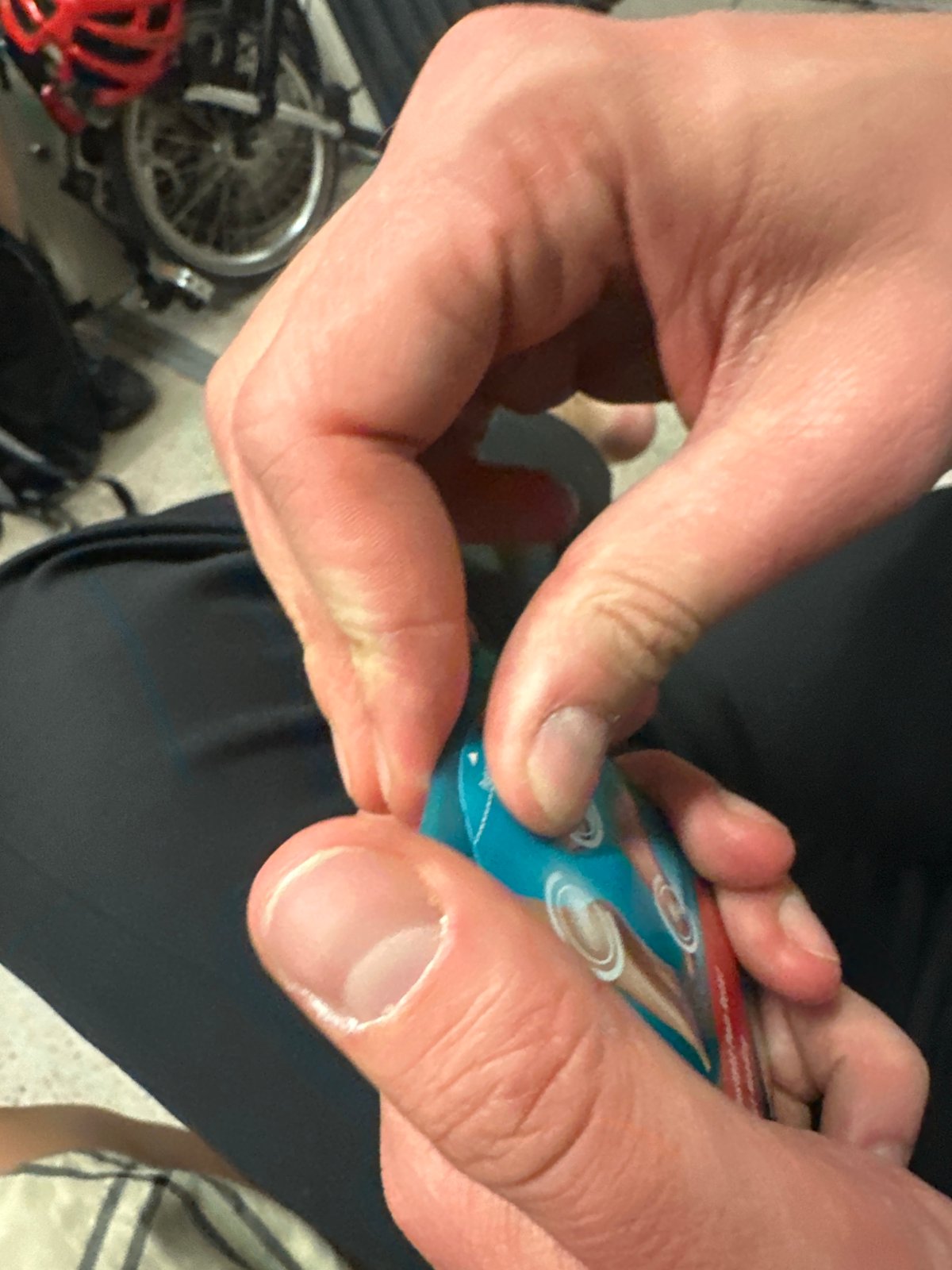 Person opens packet near bicycle at London pub area
