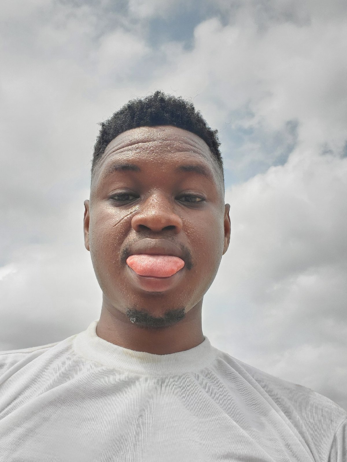 Man takes playful tongue-out selfie in Mararaba, Nigeria