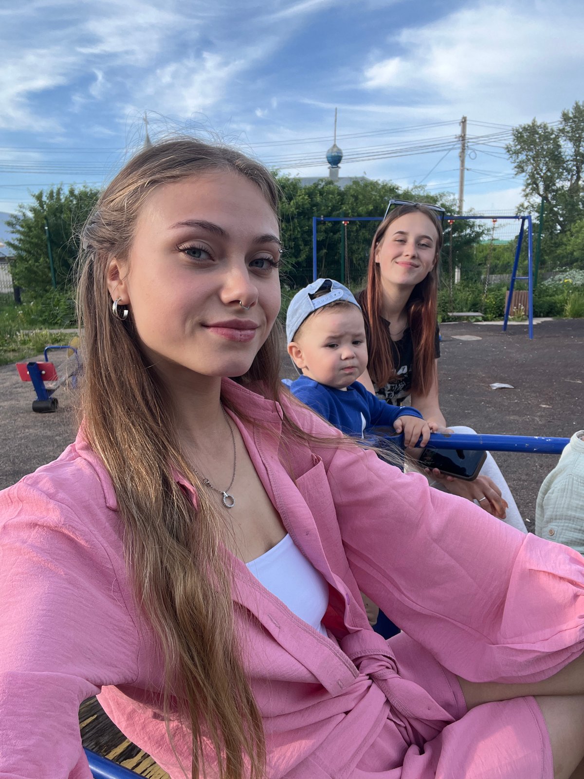 Family playground outing documented in rural Russian village