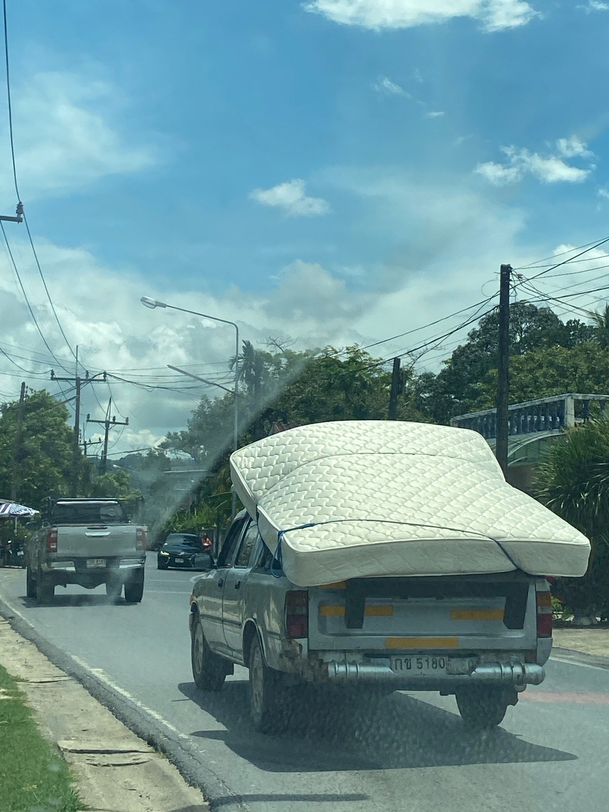 Pickup truck transports mattress on Si Sunthon road