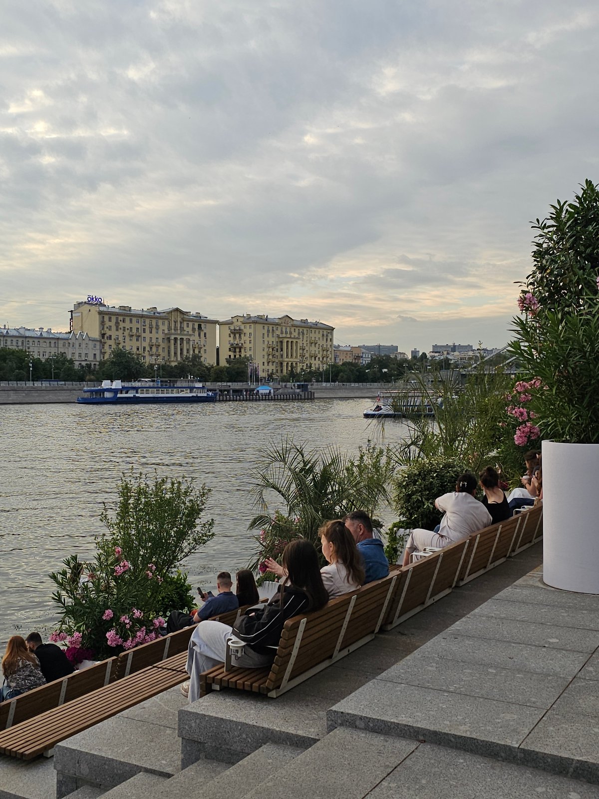 Afternoon along the Moskva River, benches, boats, and dusk skyline