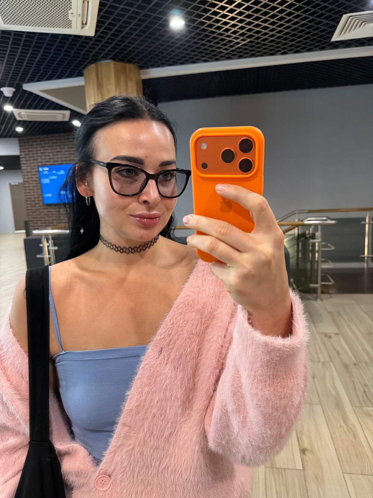 Woman takes selfie in modern building, Saint Petersburg