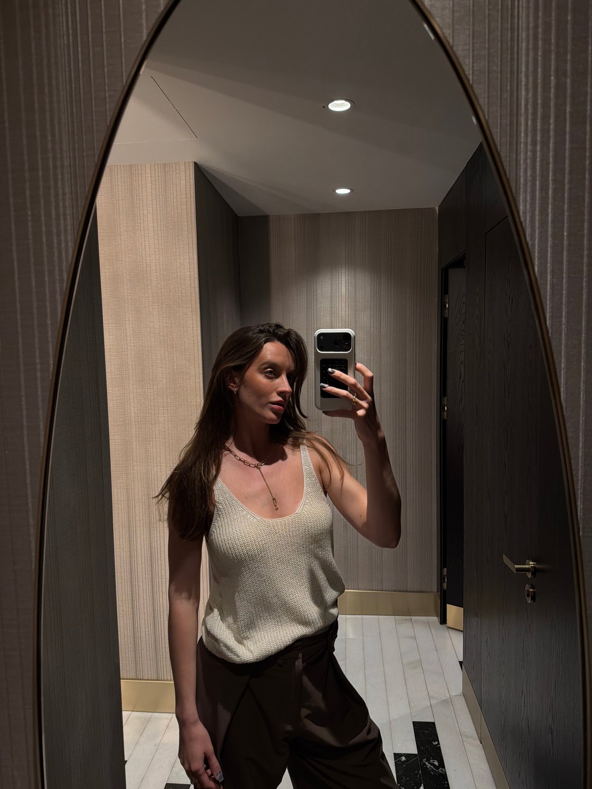 Woman takes mirror selfies in Budva hotel bathroom