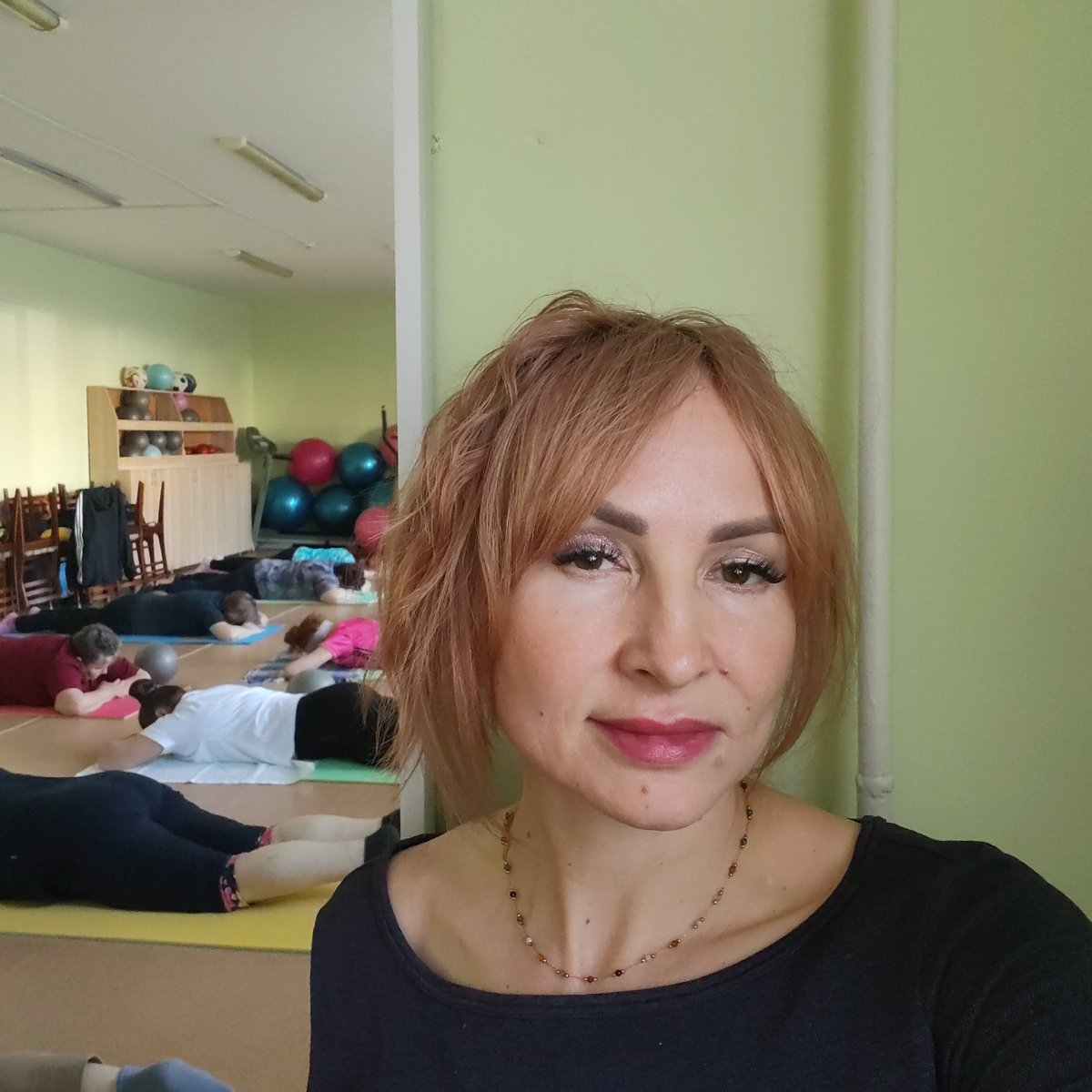 Women photograph themselves in early morning indoor sessions