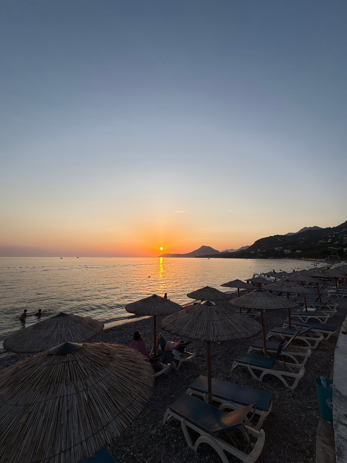 Golden hour settling over Bar's pebble beach, Montenegro