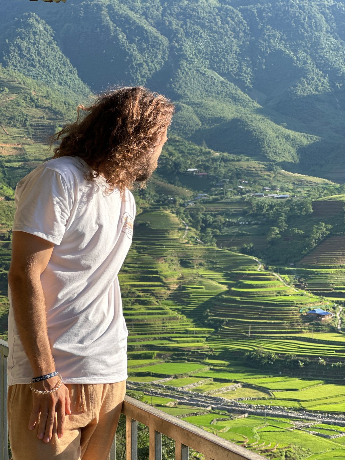 Tourist documents terraced rice fields during morning visit in Tú Lệ