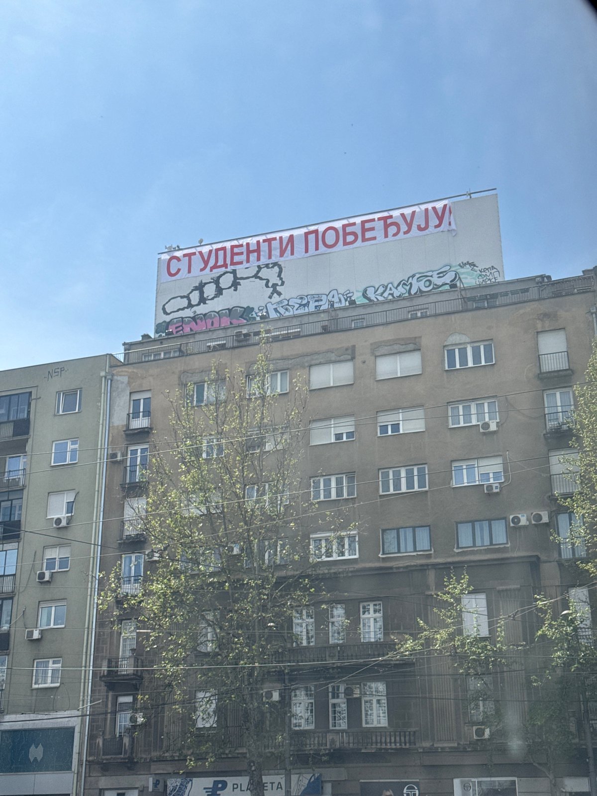 "Students Win" banner displayed on Belgrade building