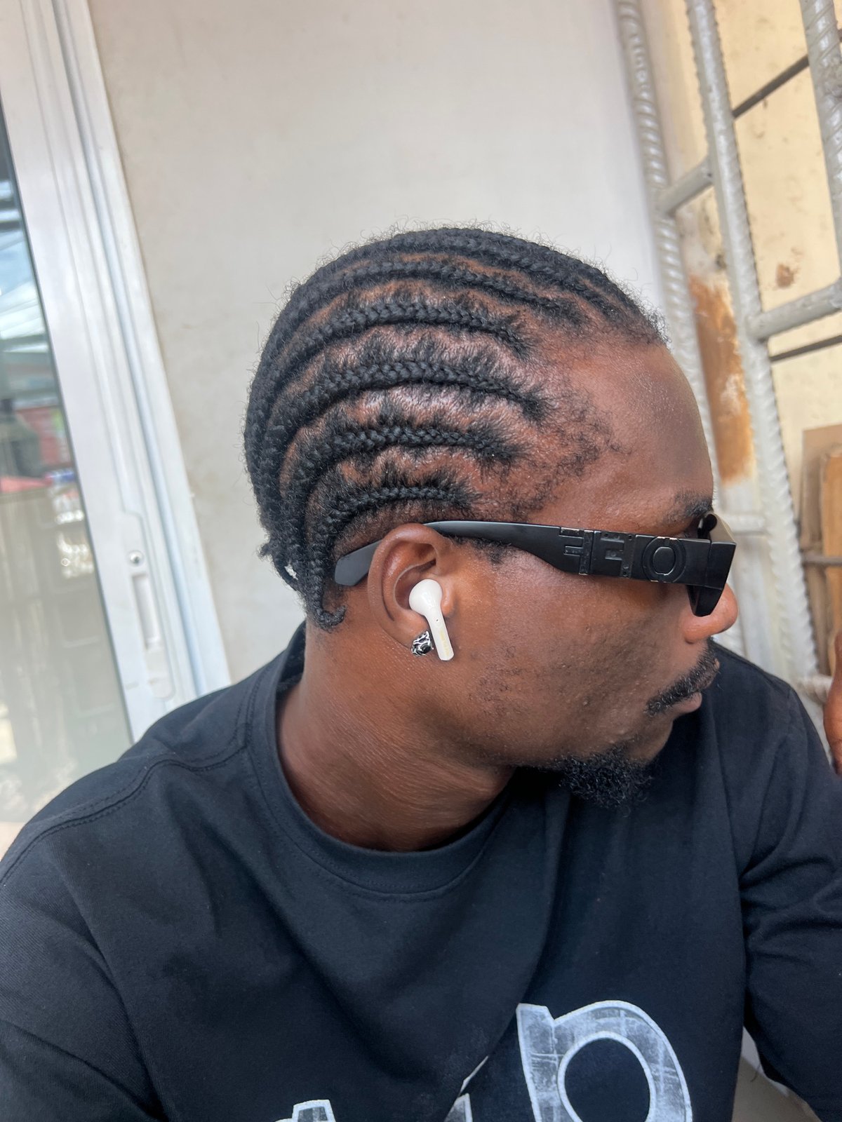 Man photographed wearing OFF sunglasses and earbuds in Ikeja