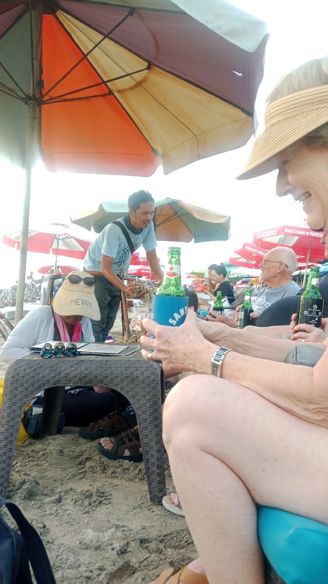 Busy morning at Kuta Beach — surf, sand, and umbrellas