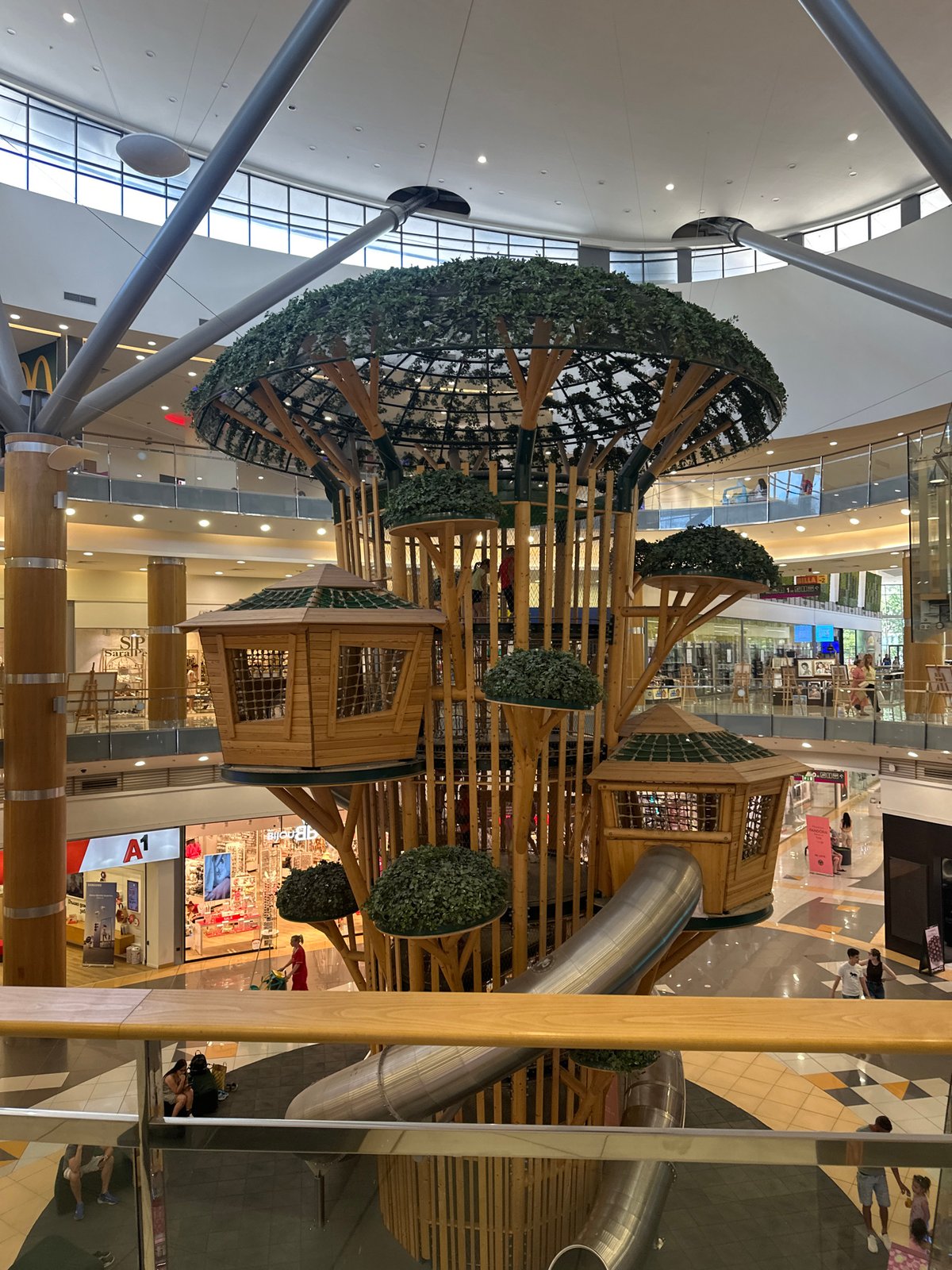 Treehouse play structure fills a shopping mall atrium
