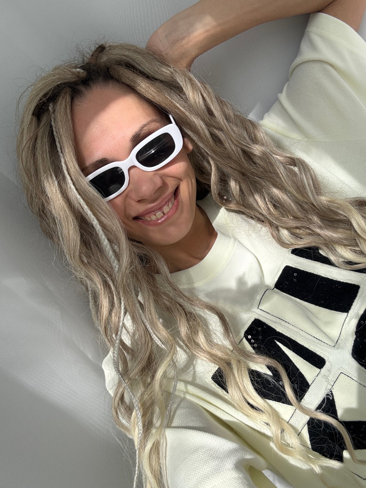 Woman relaxes indoors wearing sunglasses in Rusanovo, Russia