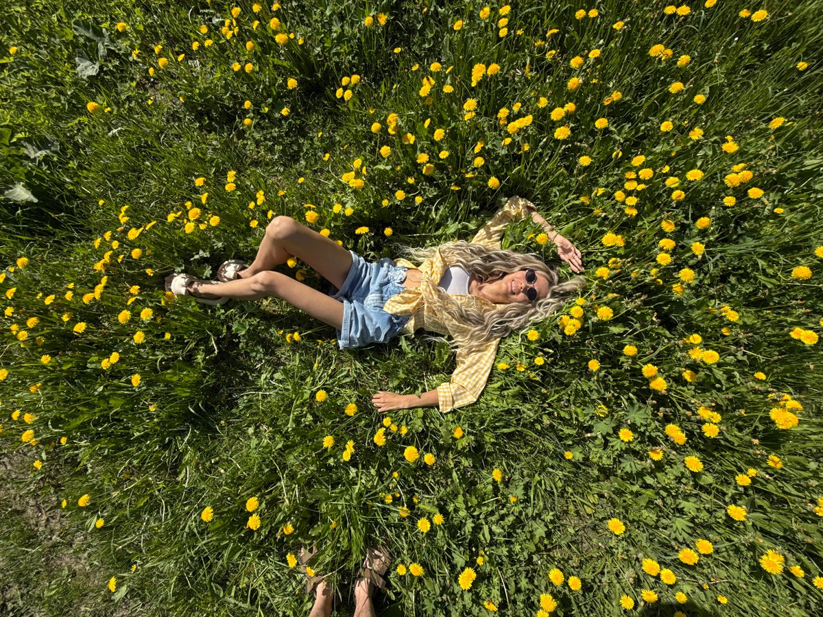 Woman rests in yellow flower field in Шебунино