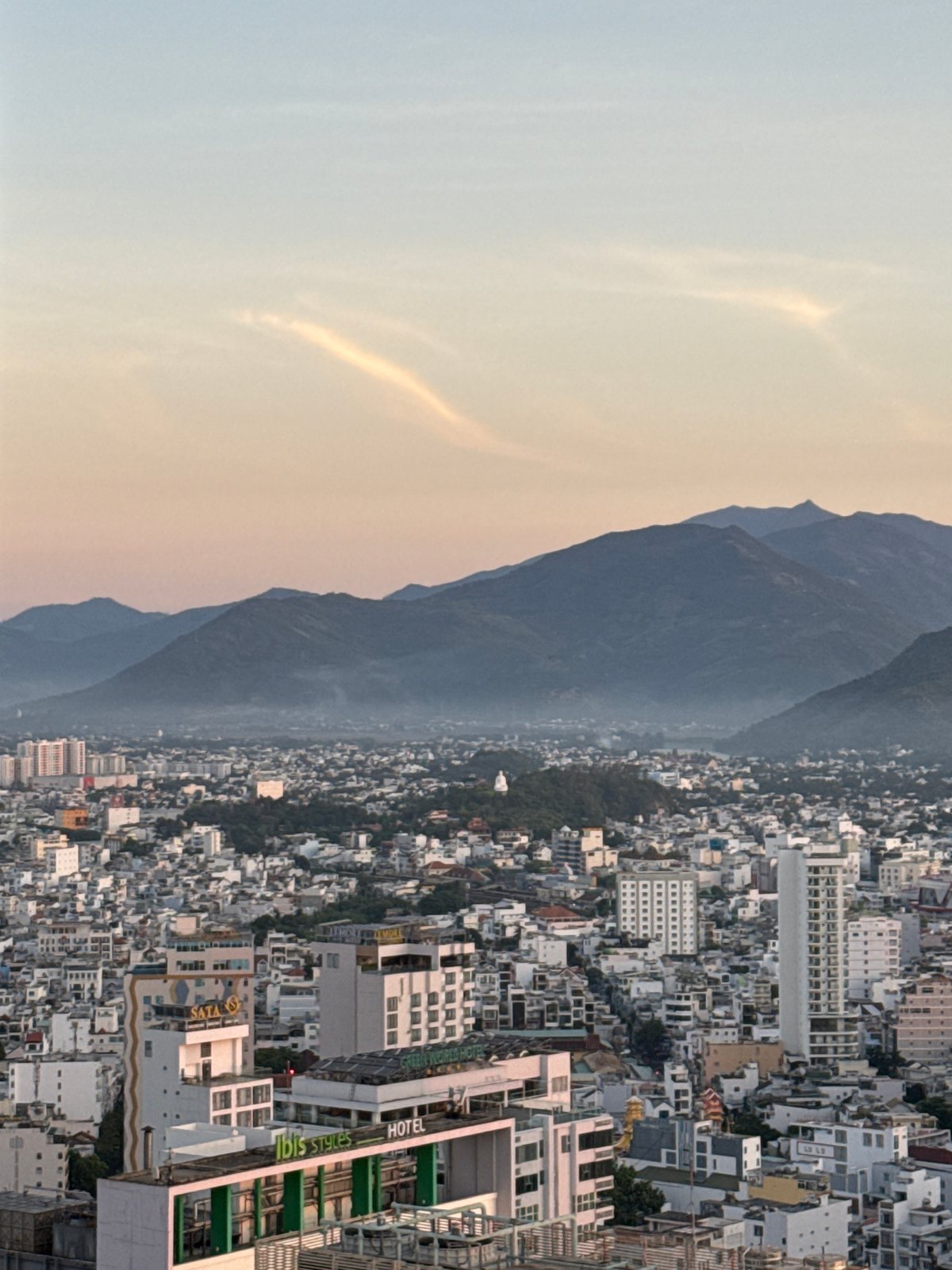 Dusk views over Nha Trang's skyline, coast, and mountains