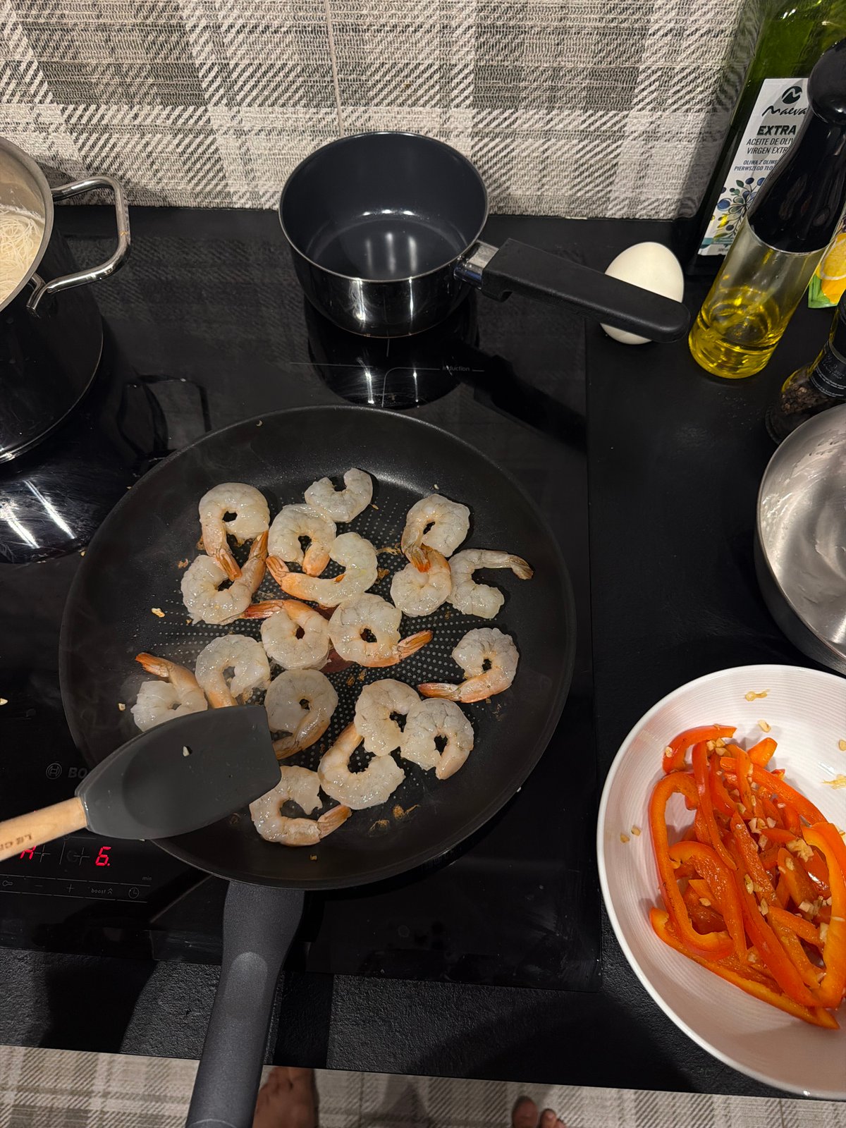 Shrimp hitting the pan on a Warsaw induction stovetop