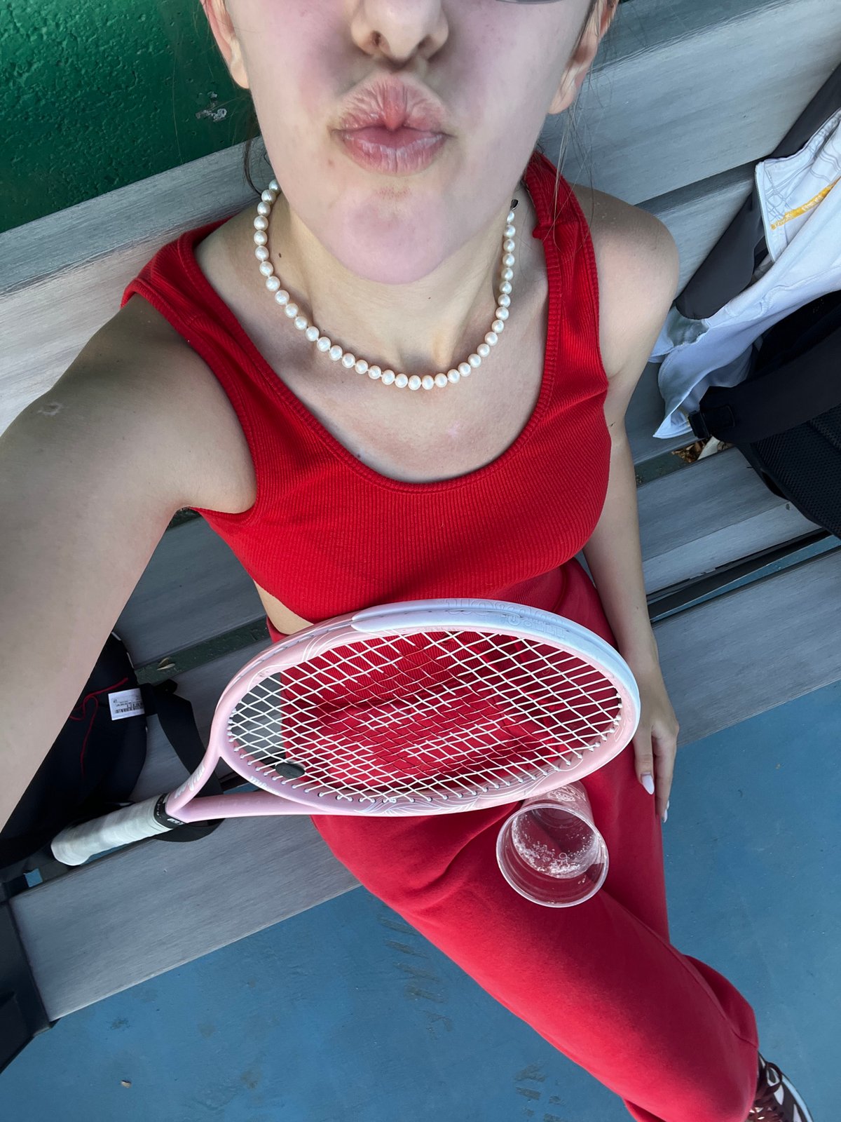 Tennis player takes break on court bleachers in Bulgaria