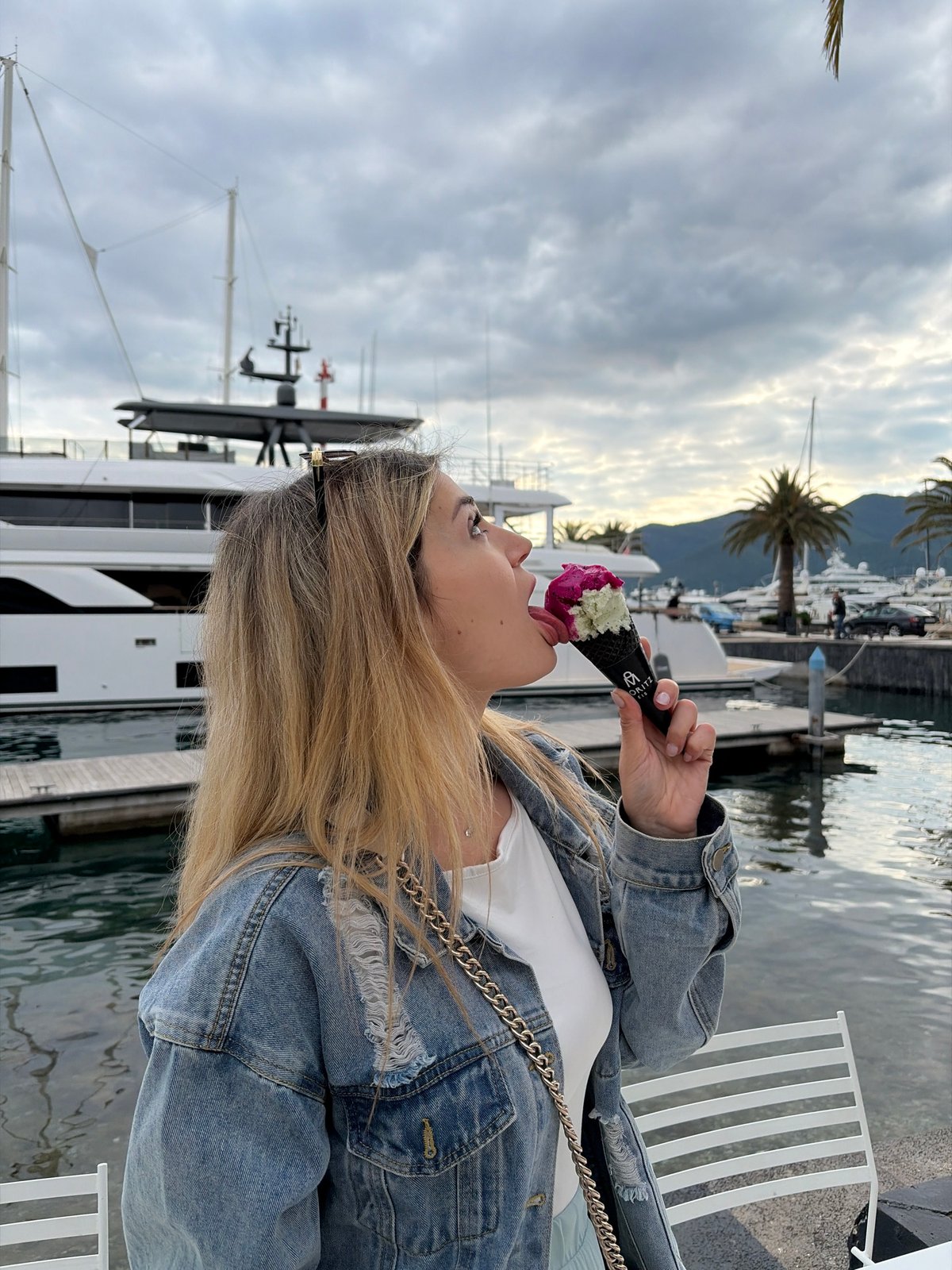 Woman enjoys ice cream tour around Tivat marina Montenegro