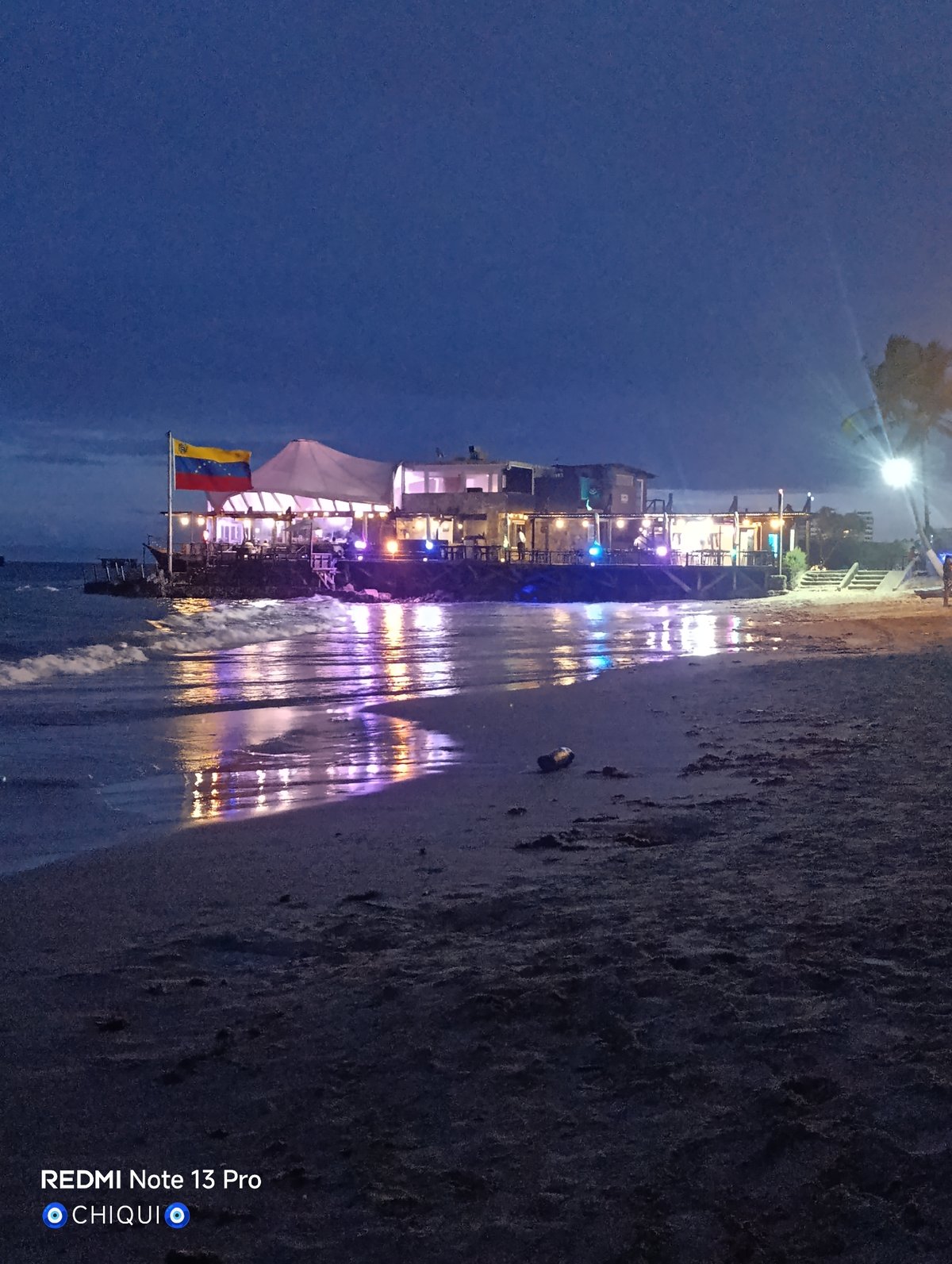 Evening beach documentation captures Pampatar waterfront transition to nighttime