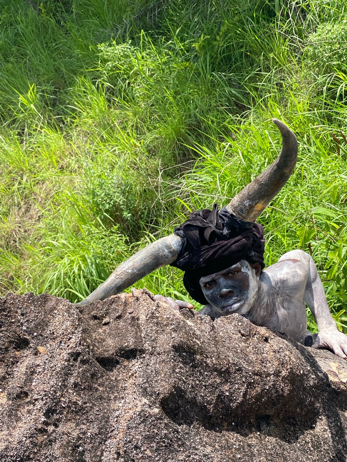 Horned costumed figure documented on rocks in Ufueseni, Nigeria