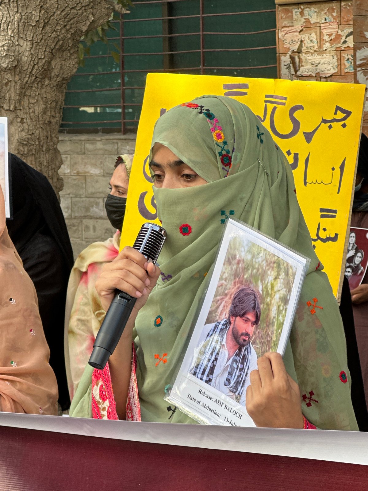 Protest in Quetta with speakers holding photographs of missing persons
