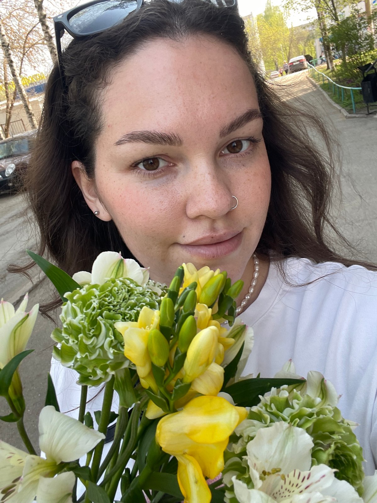 Woman with flowers, athletic field activity observed in Izhevsk