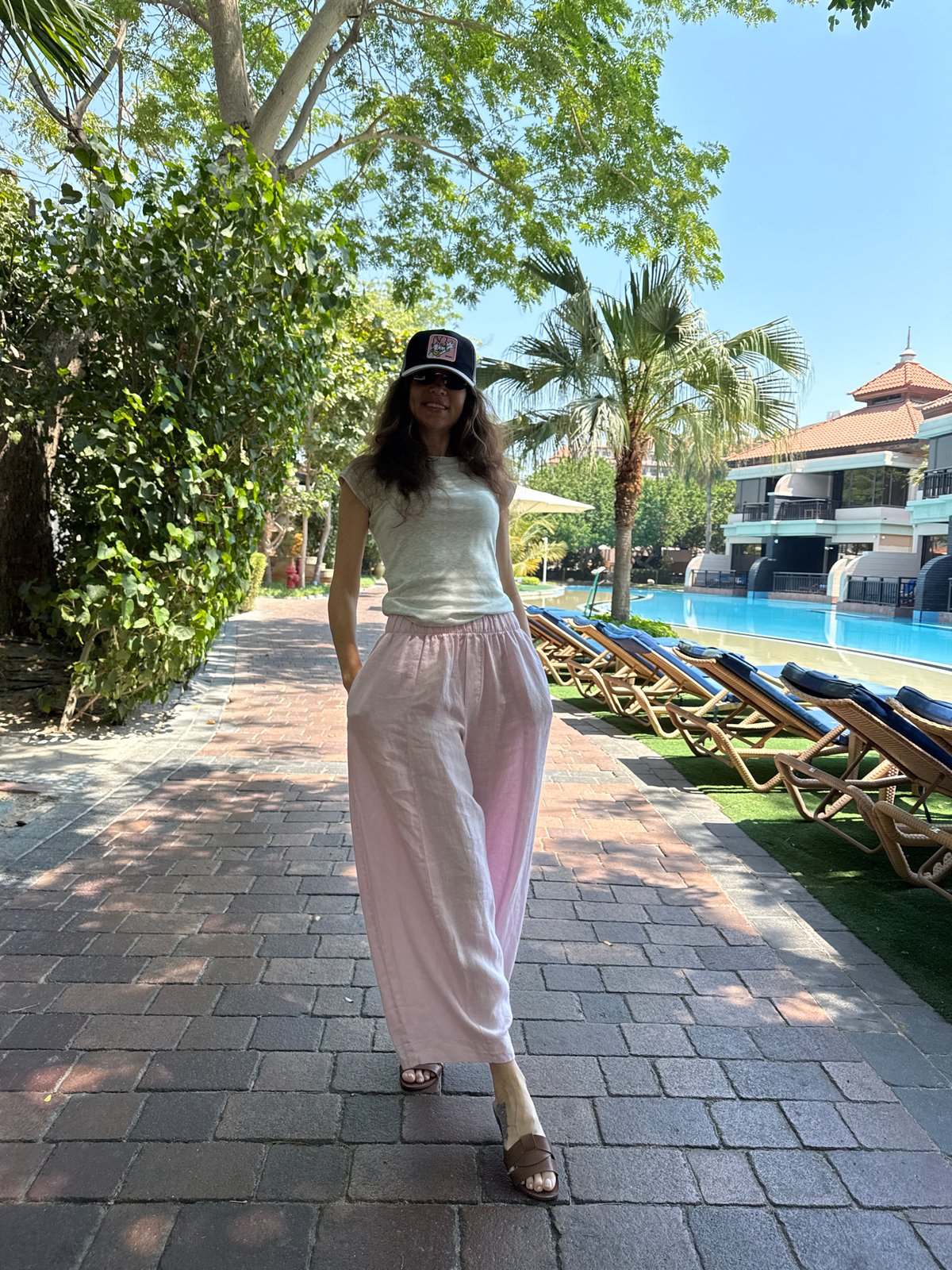 Woman films morning yoga session by Dubai pool