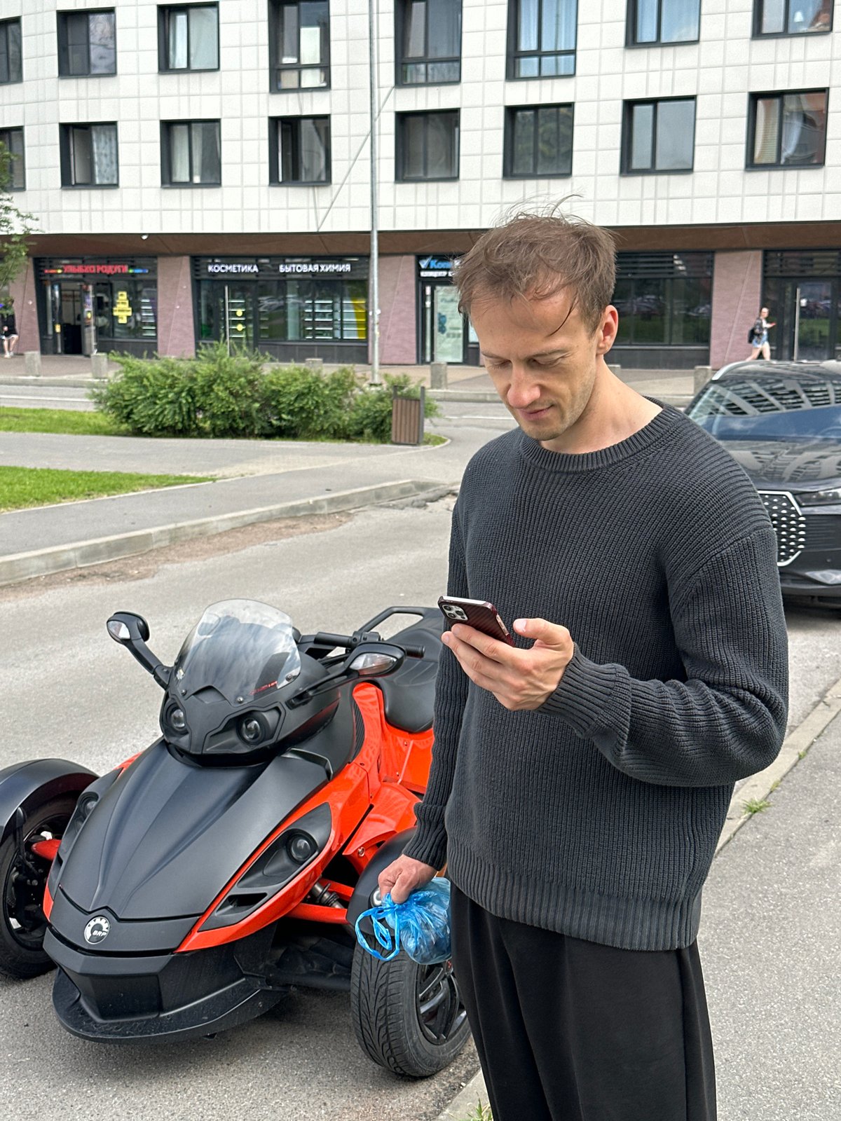 Can-Am Spyders and custom cars parked in Murino, Russia