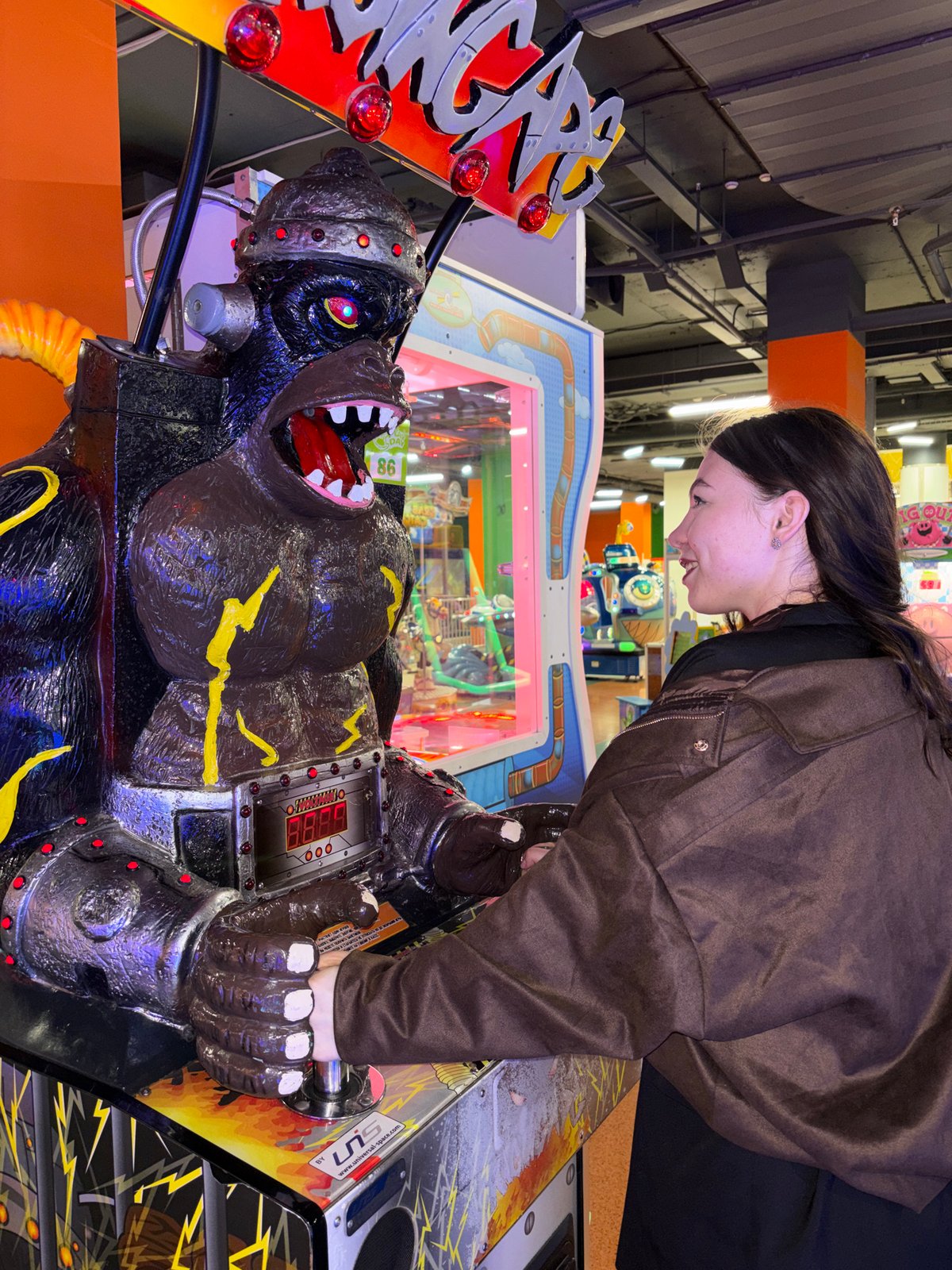 Woman plays gorilla arcade game in Perm, Russia
