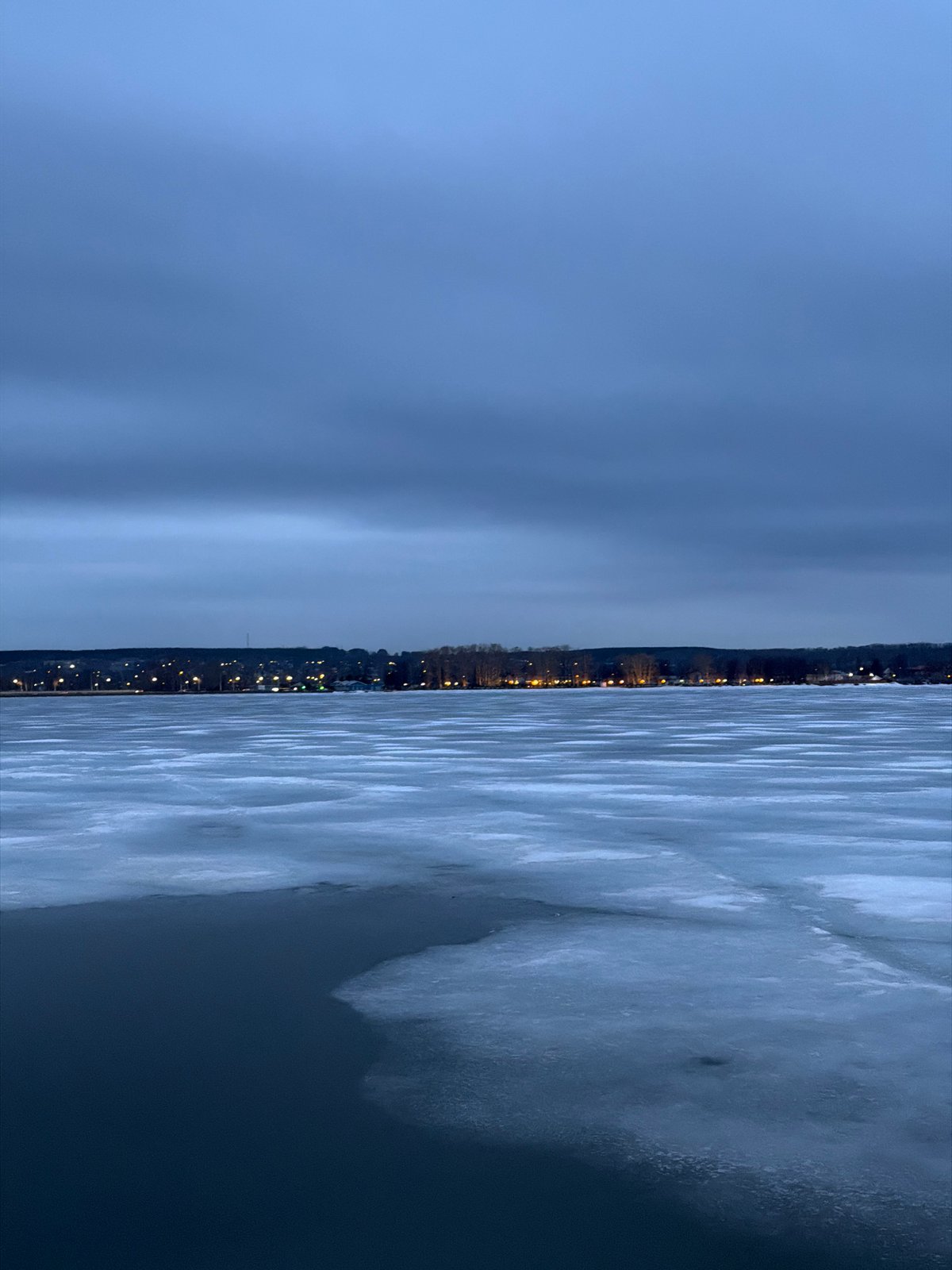 Twilight scenes captured across frozen Votkinsk, Russia including piano sculpture