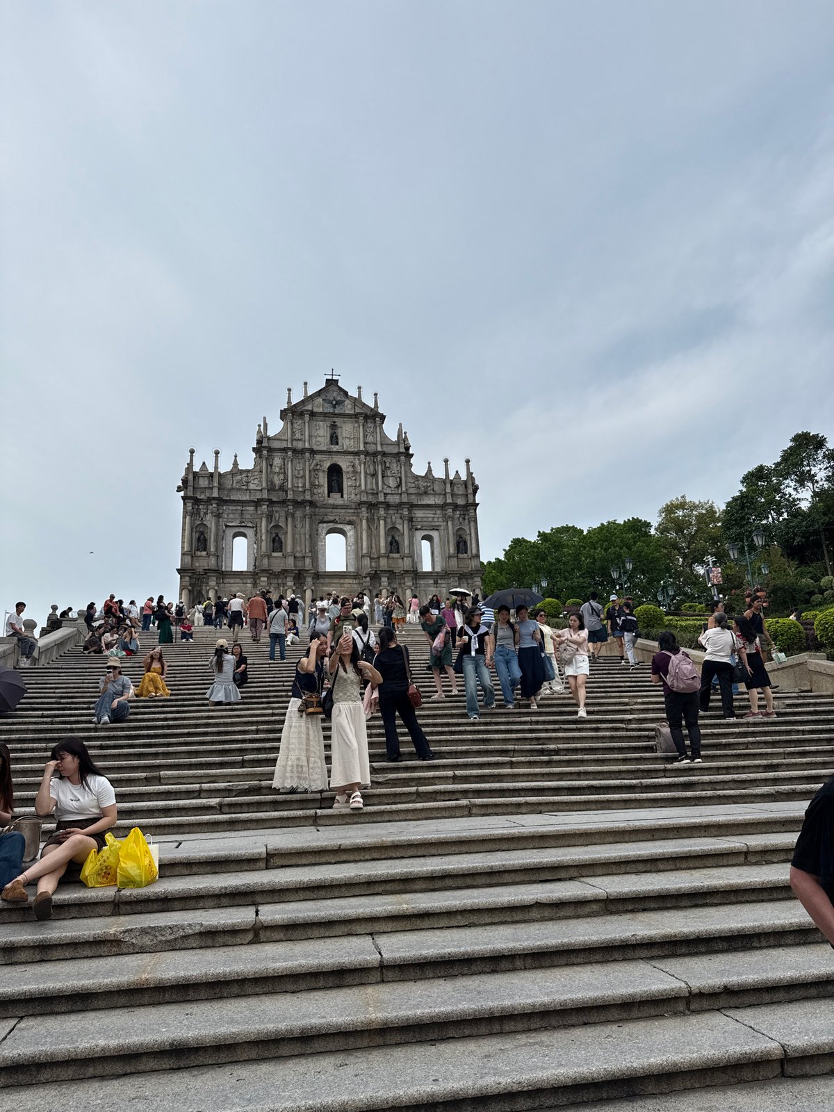Tourist crowds gather at historic St. Paul's Ruins in Macau