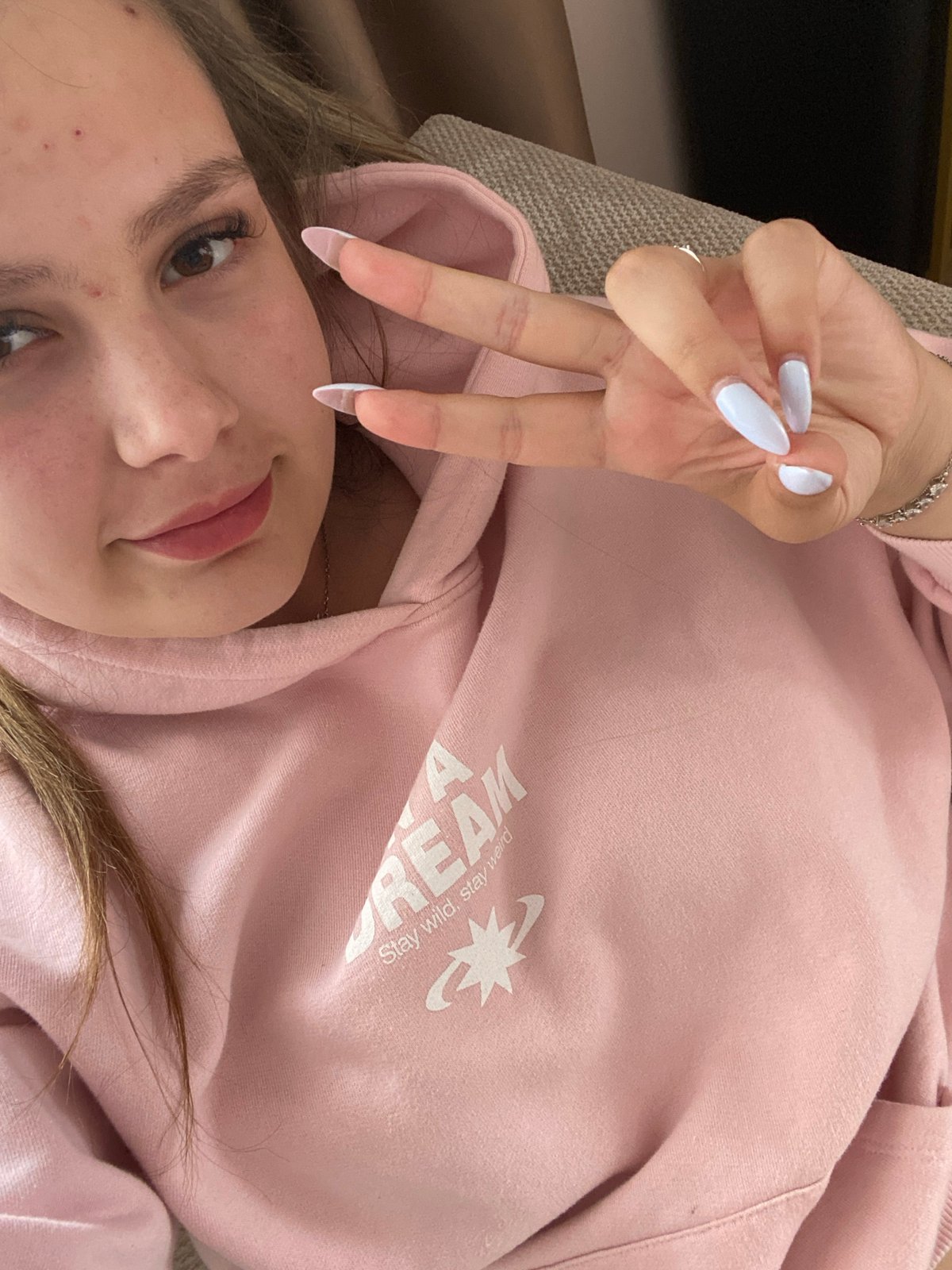Person takes peaceful selfie in pink hoodie, Pletena Bulgaria