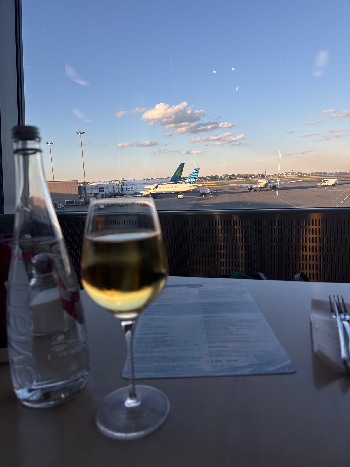 Inside Logan Airport's lounge, planes visible on the tarmac