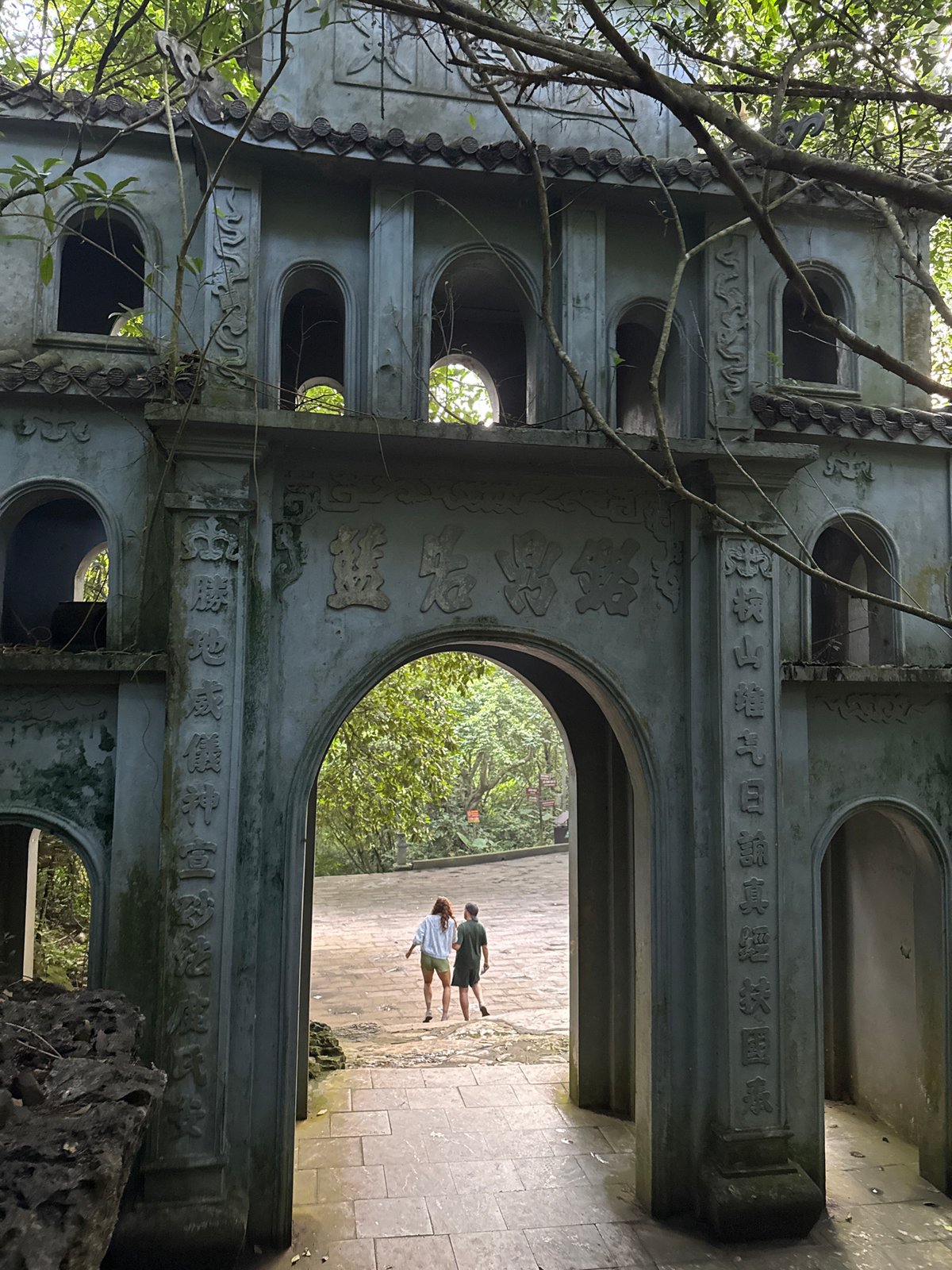 Tourists explore ancient temple grounds in Vietnamese ward