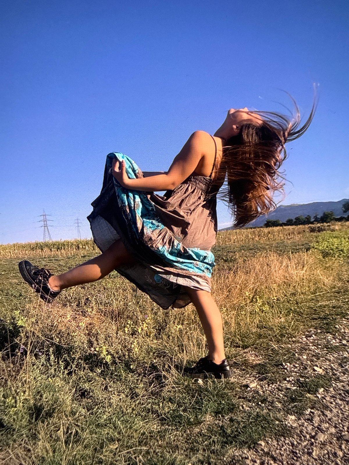 Woman captured mid-movement on grassy field in Sofia
