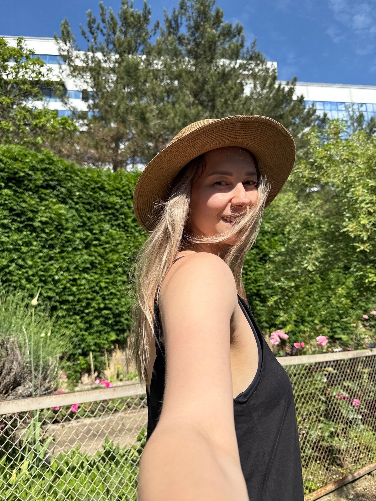 Tourist in straw hat sightseeing around coastal Nebug, Russia