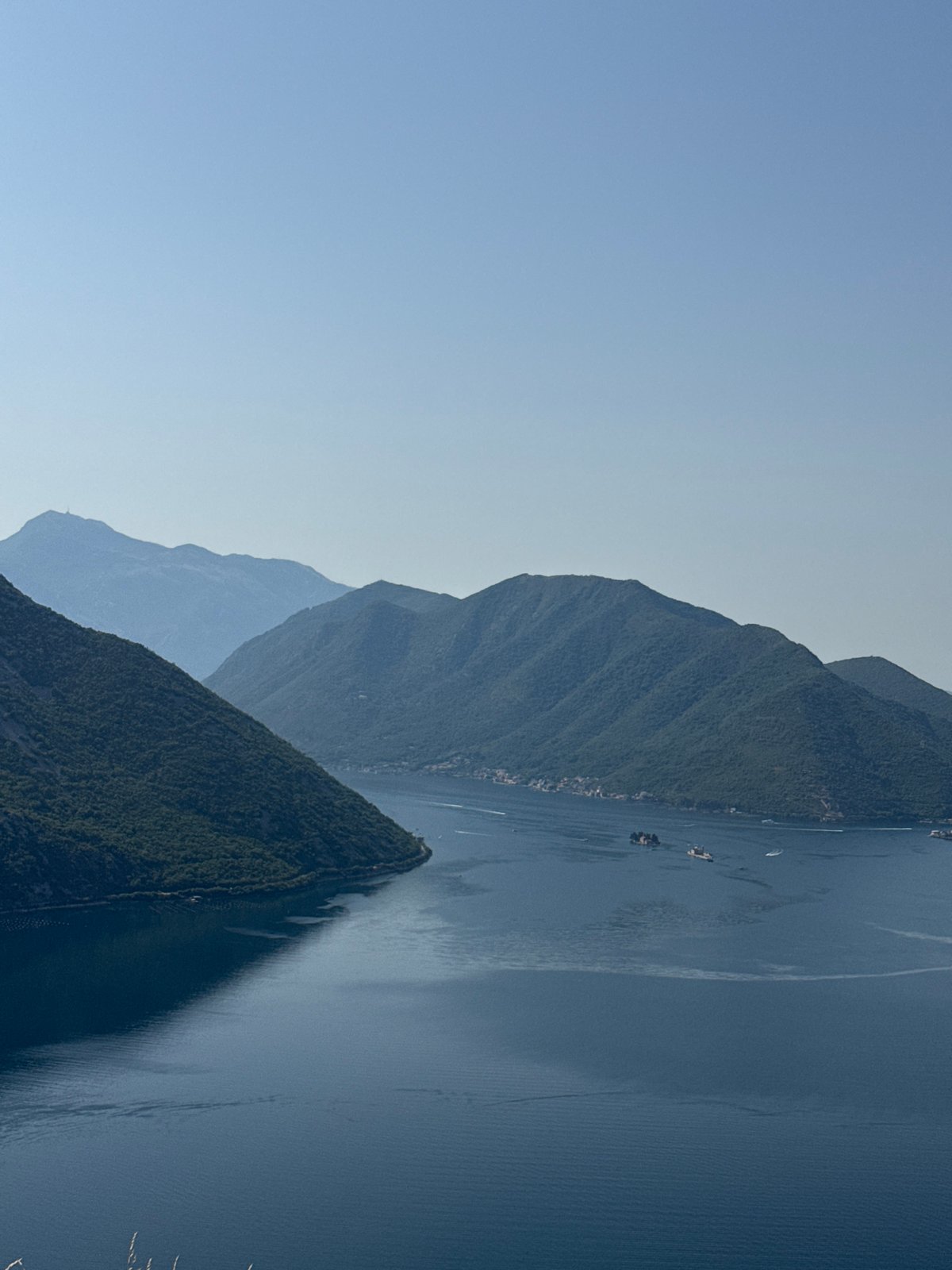 Bay of Kotor's mountains and water on a July morning