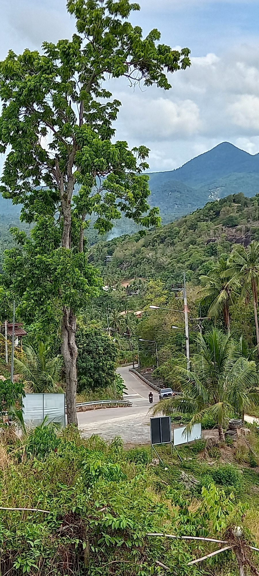 Motorcycle travels mountain road in Baan Tai, Thailand