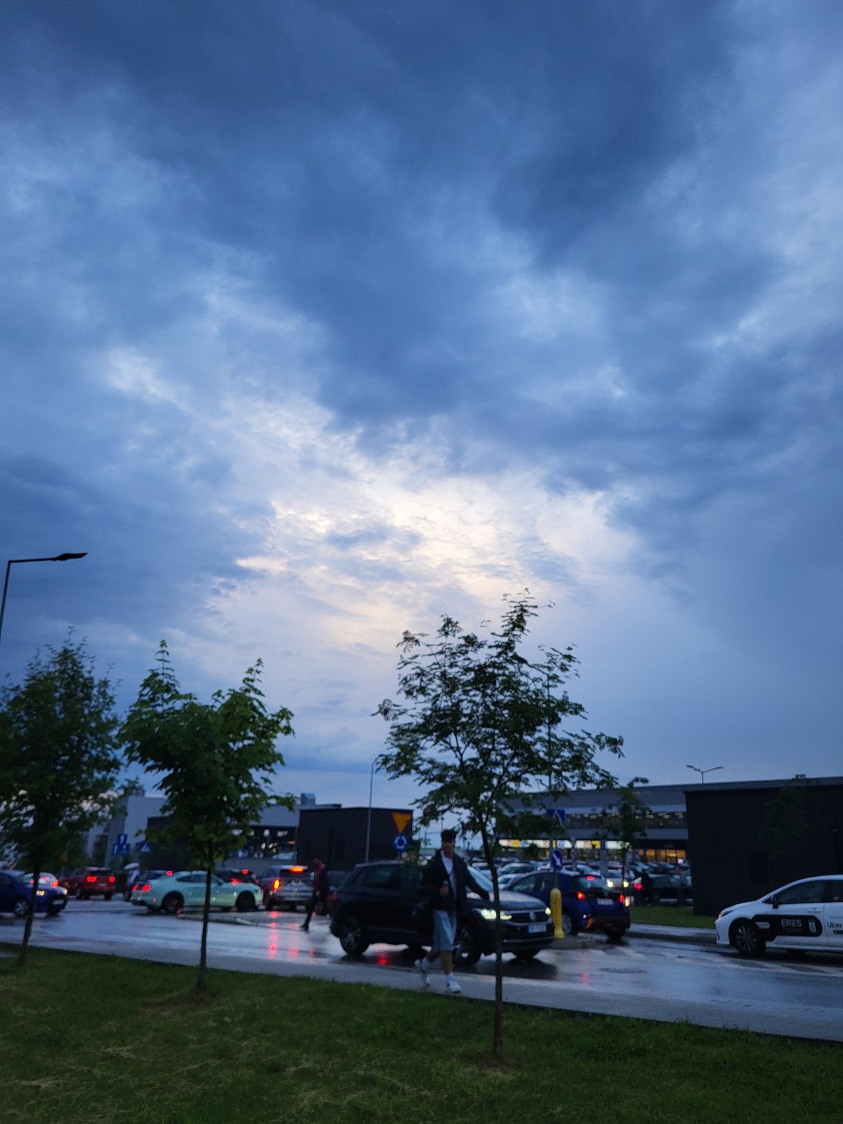 Rainy evening documented across urban residential neighborhood, June 2026
