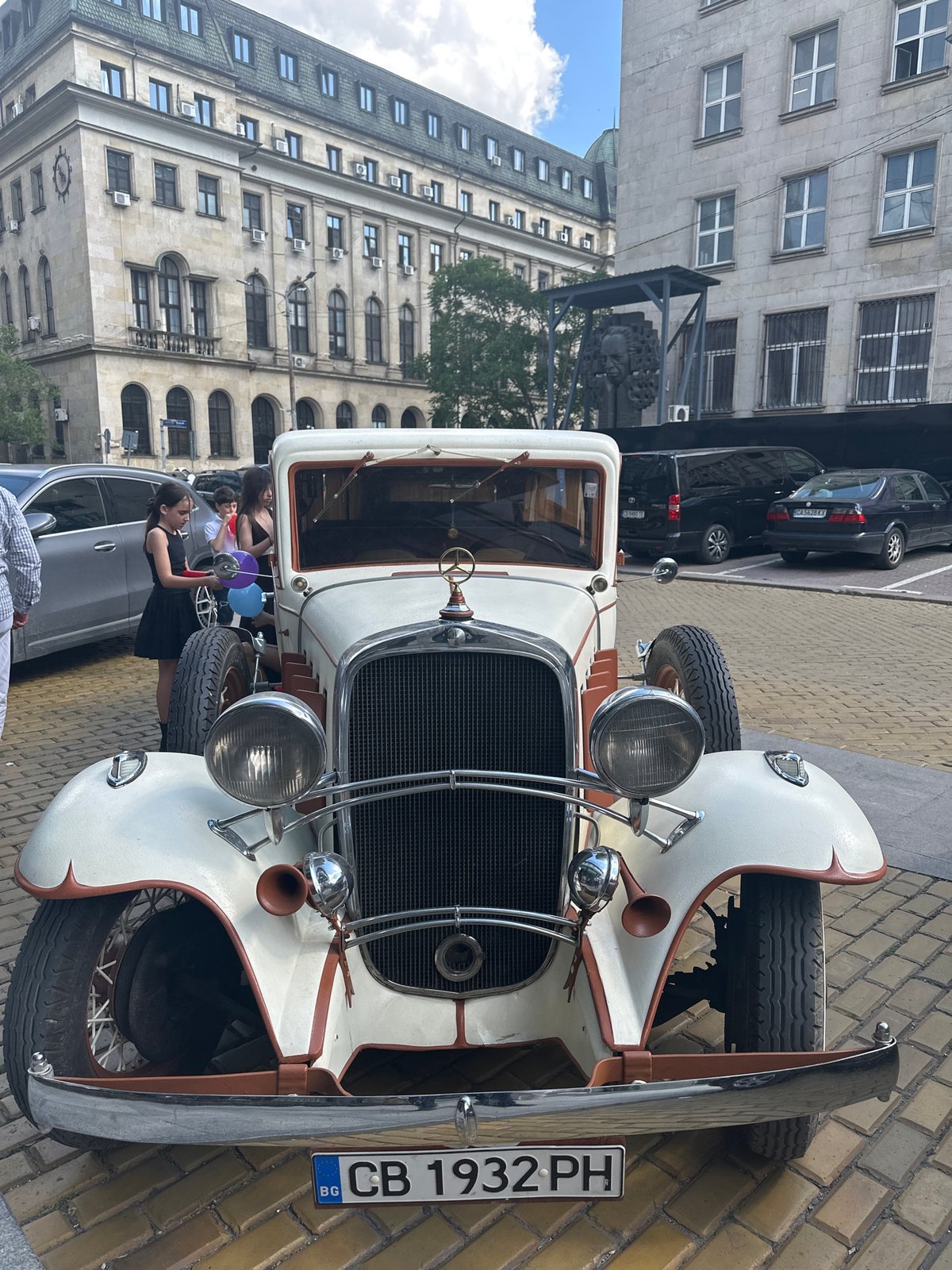 Vintage white classic car spotted on Sofia's brick streets