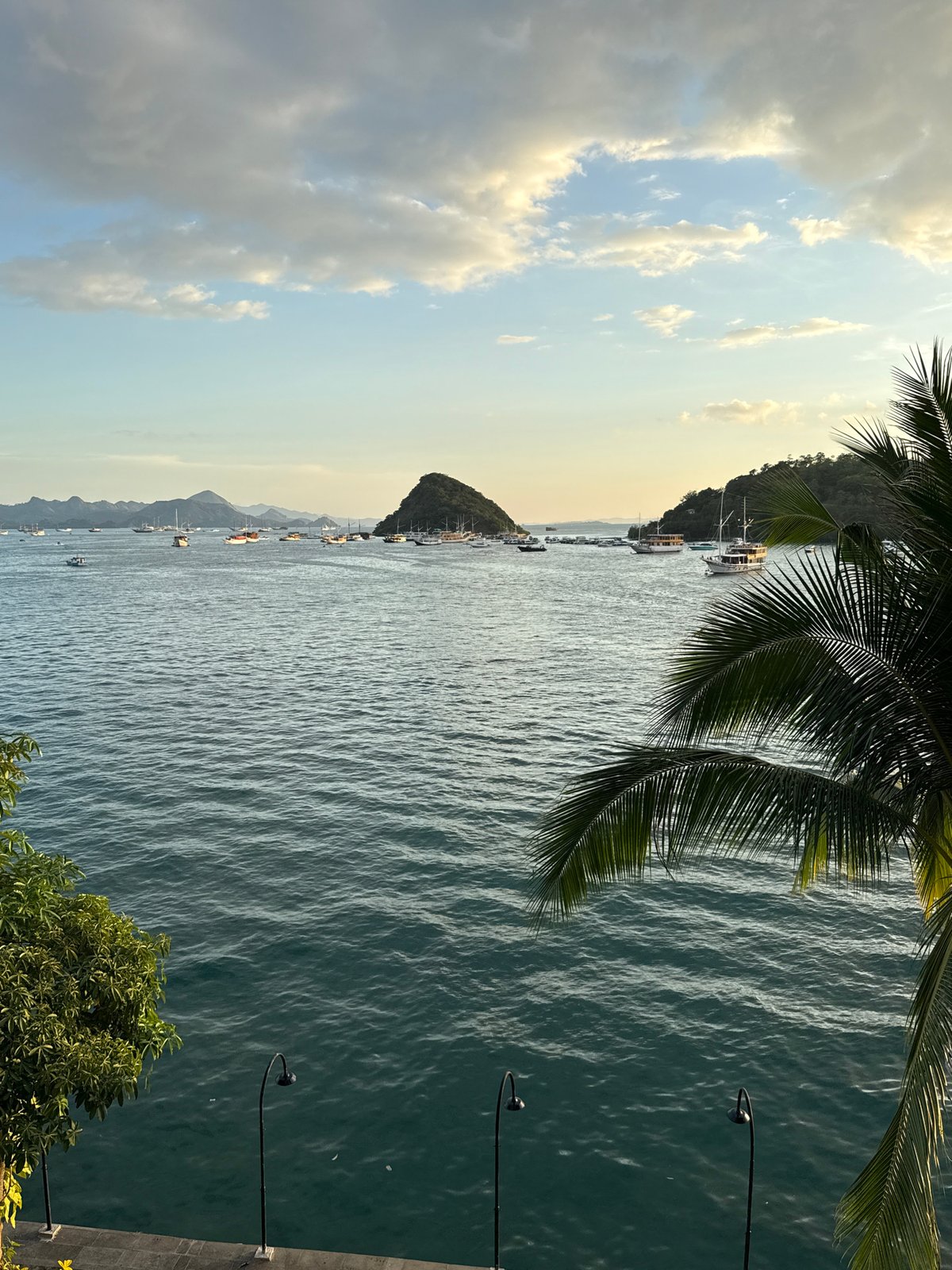 Tourist captures scenic harbor and market views in Labuan Bajo